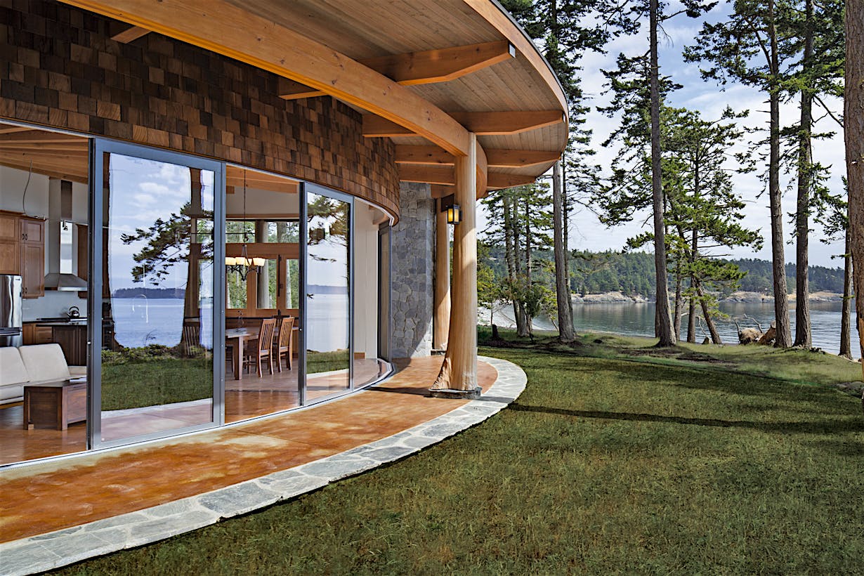 curved sliding glass door system in a waterfront home