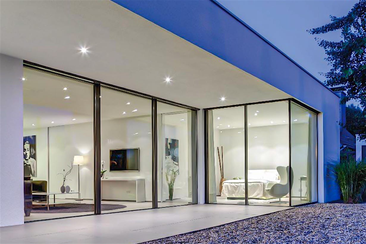 minimal exterior glass wall systems in modern bedroom
