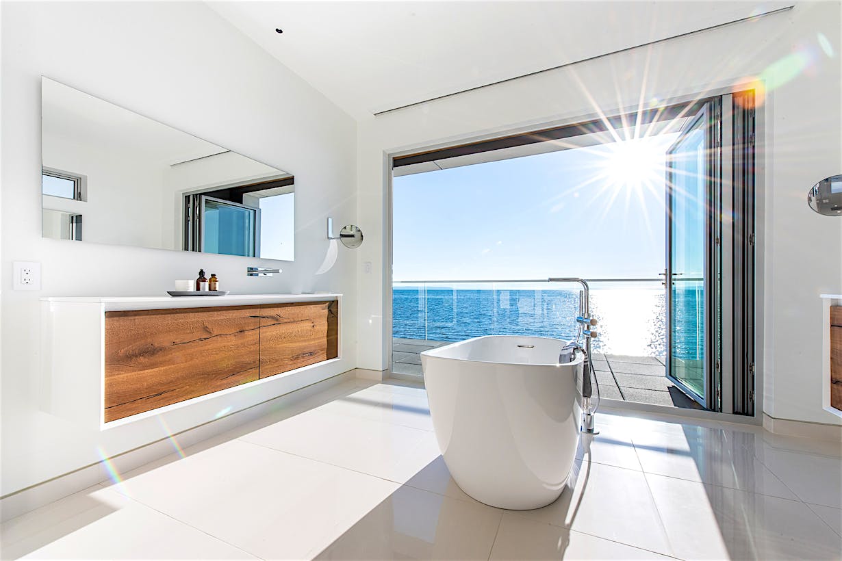 retractable glass walls create bathroom oasis