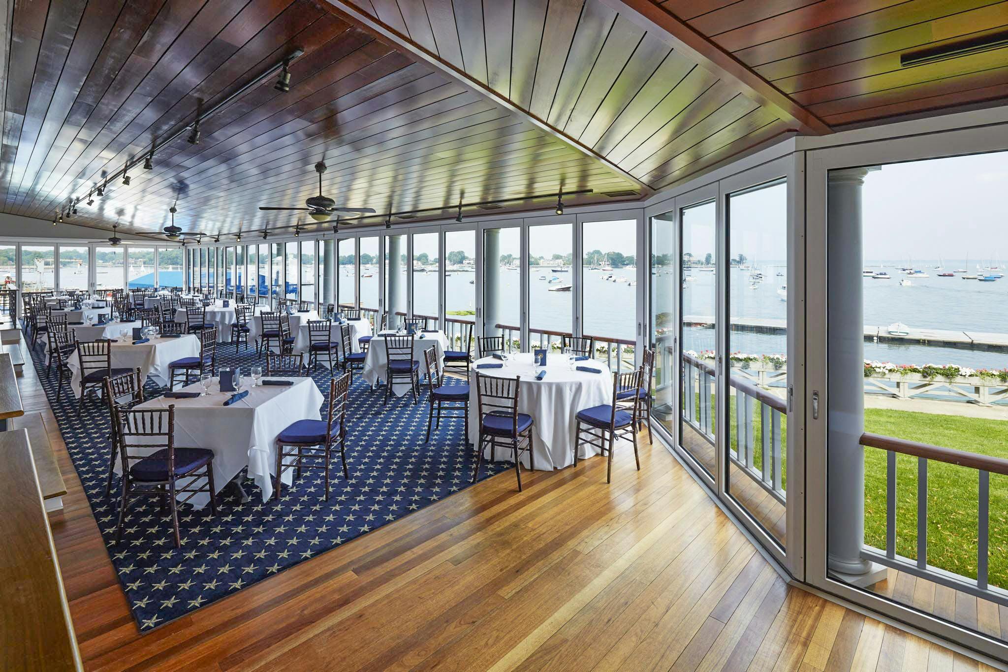 indoor outdoor dining at country club with commercial glass walls