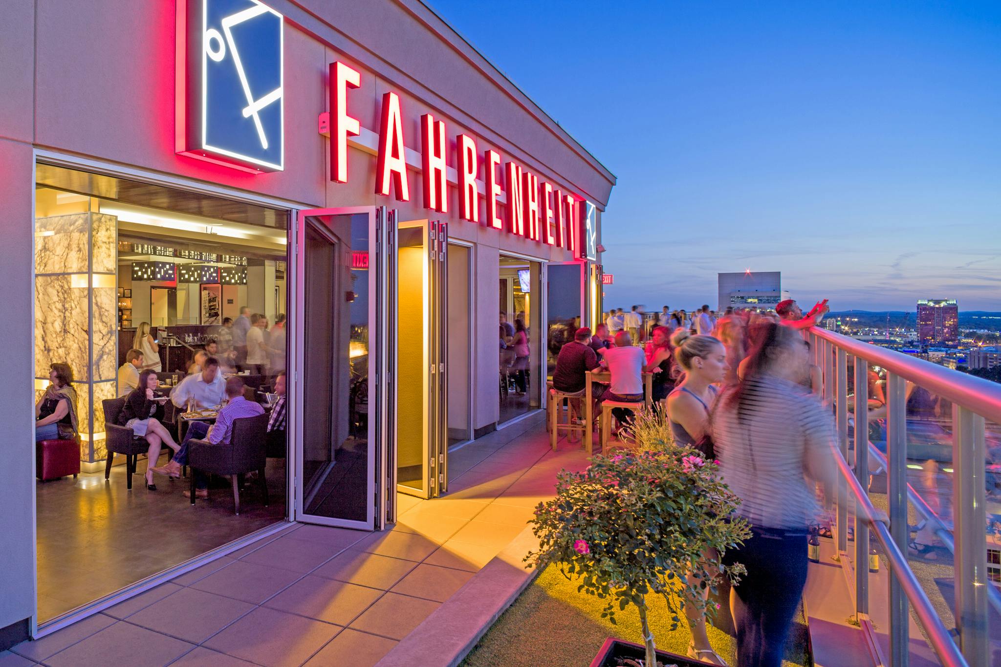 commercial folding glass walls in rooftop bar