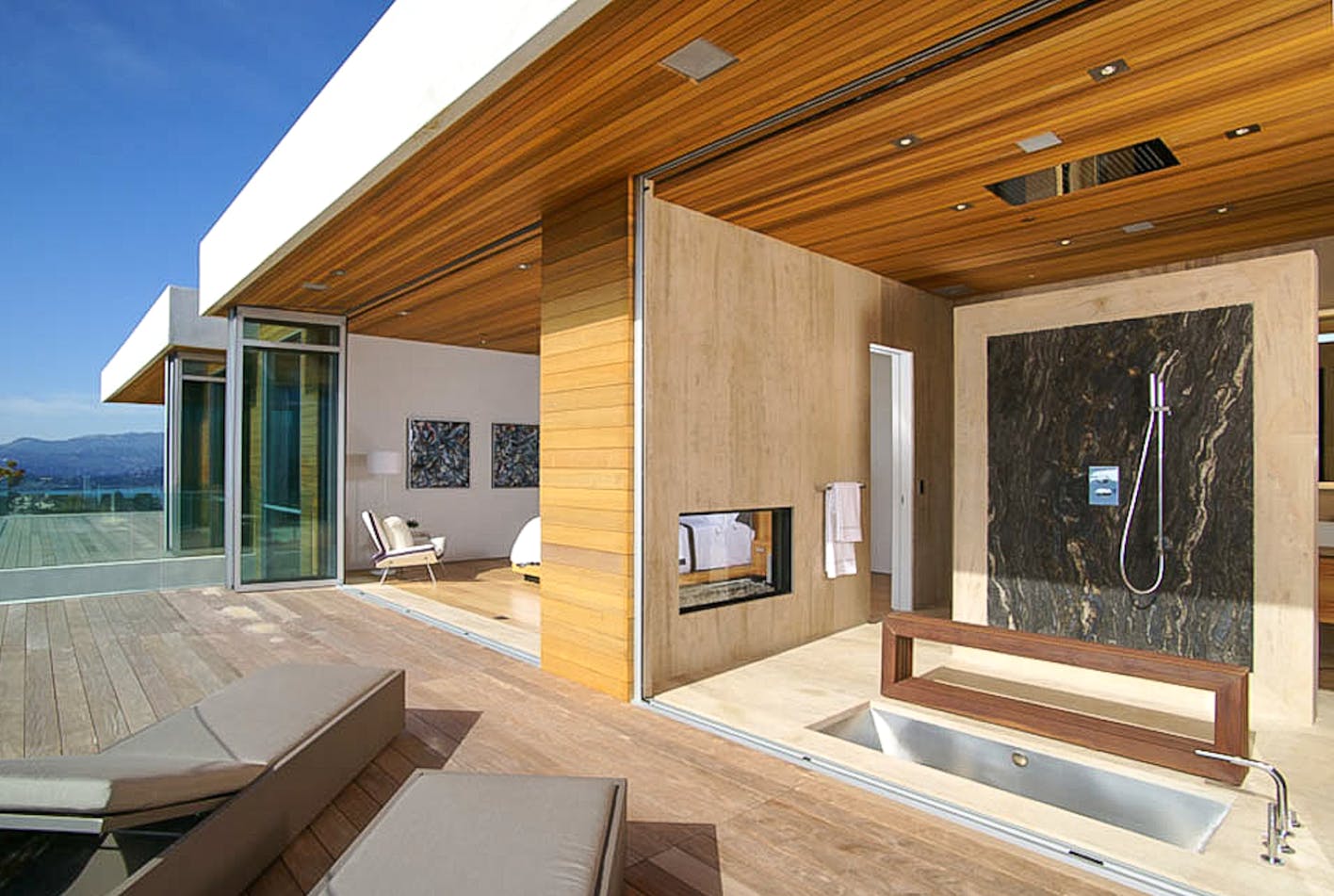 retractable glass doors create indoor outdoor bathroom