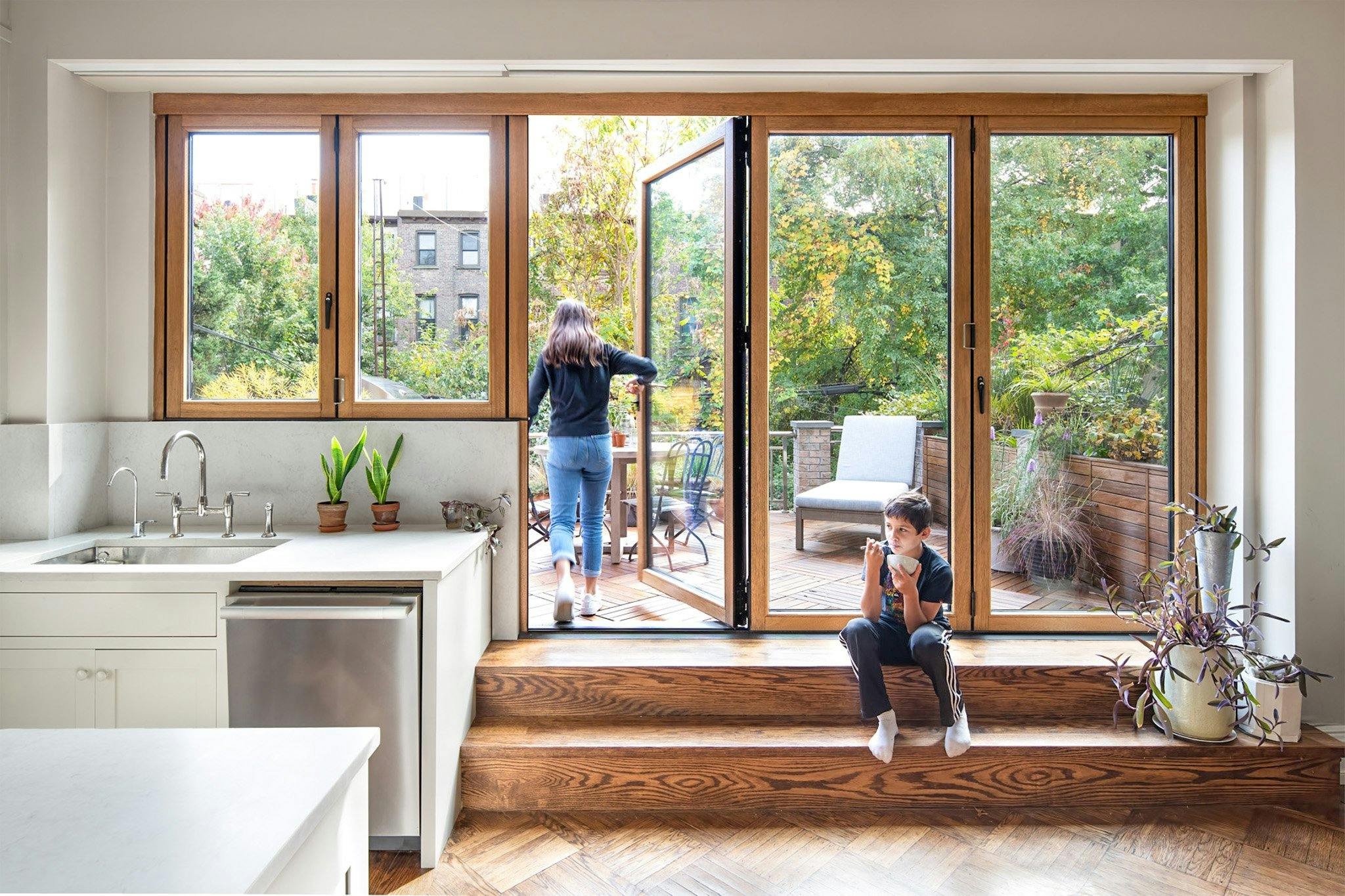 aluminum clad folding glass wall system in kitchen