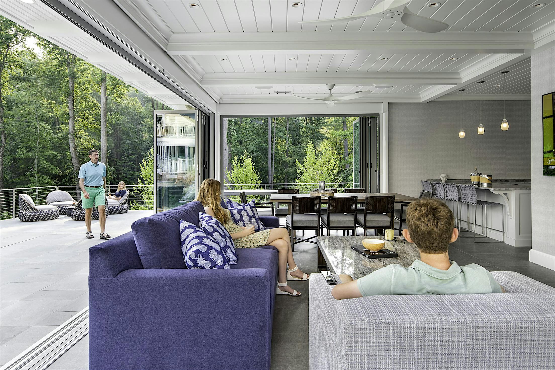 inside pool house with open folding glass wall systems