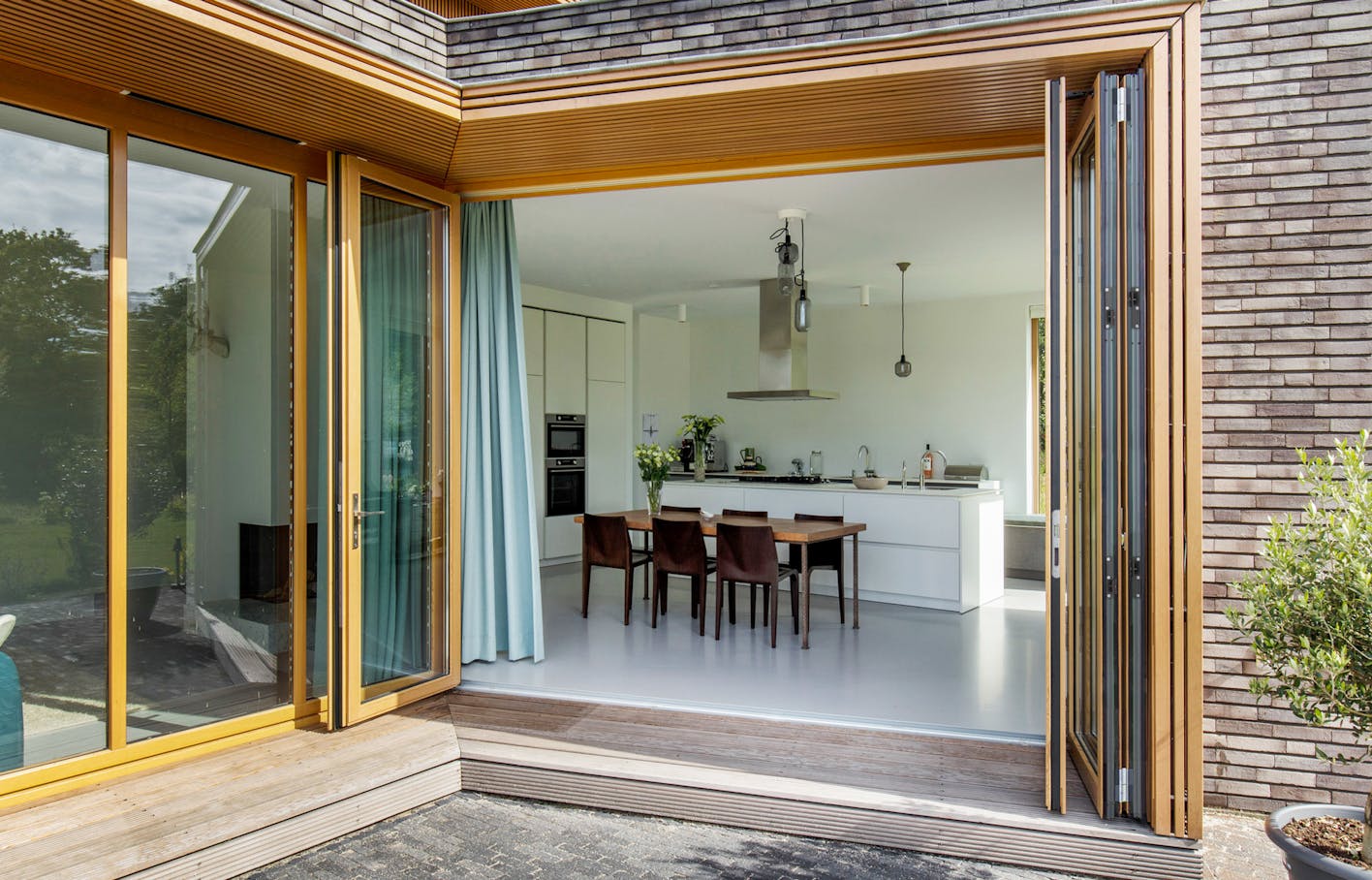 wood framed folding glass doors in modern homes