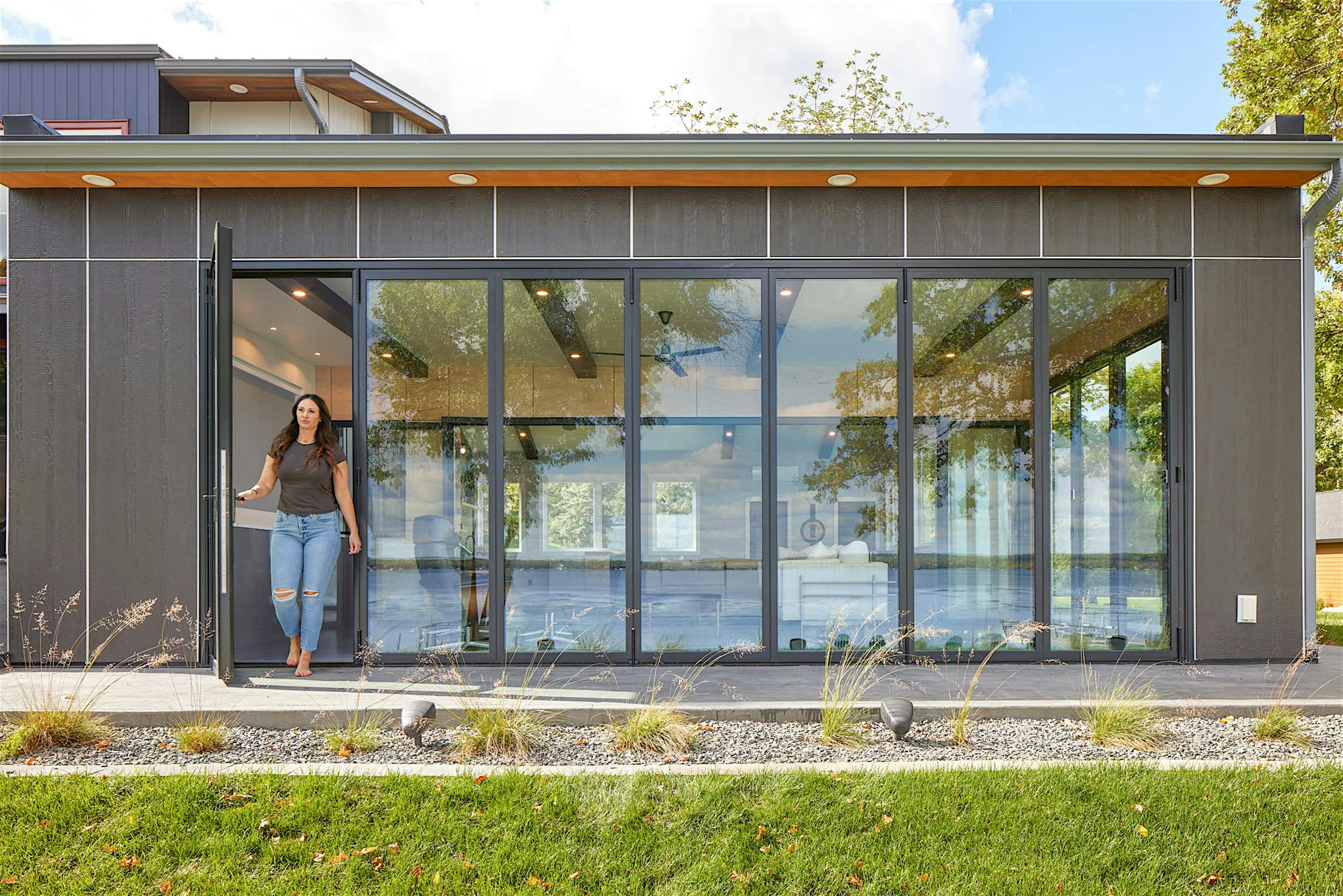 Swing door in folding glass wall systems