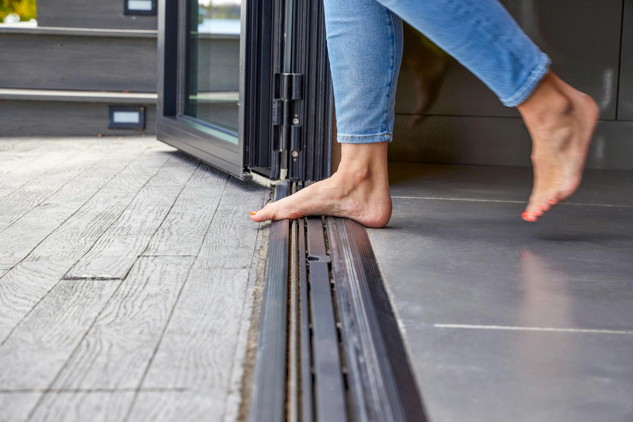 barefoot-friendly transitions with folding glass walls by NanaWall