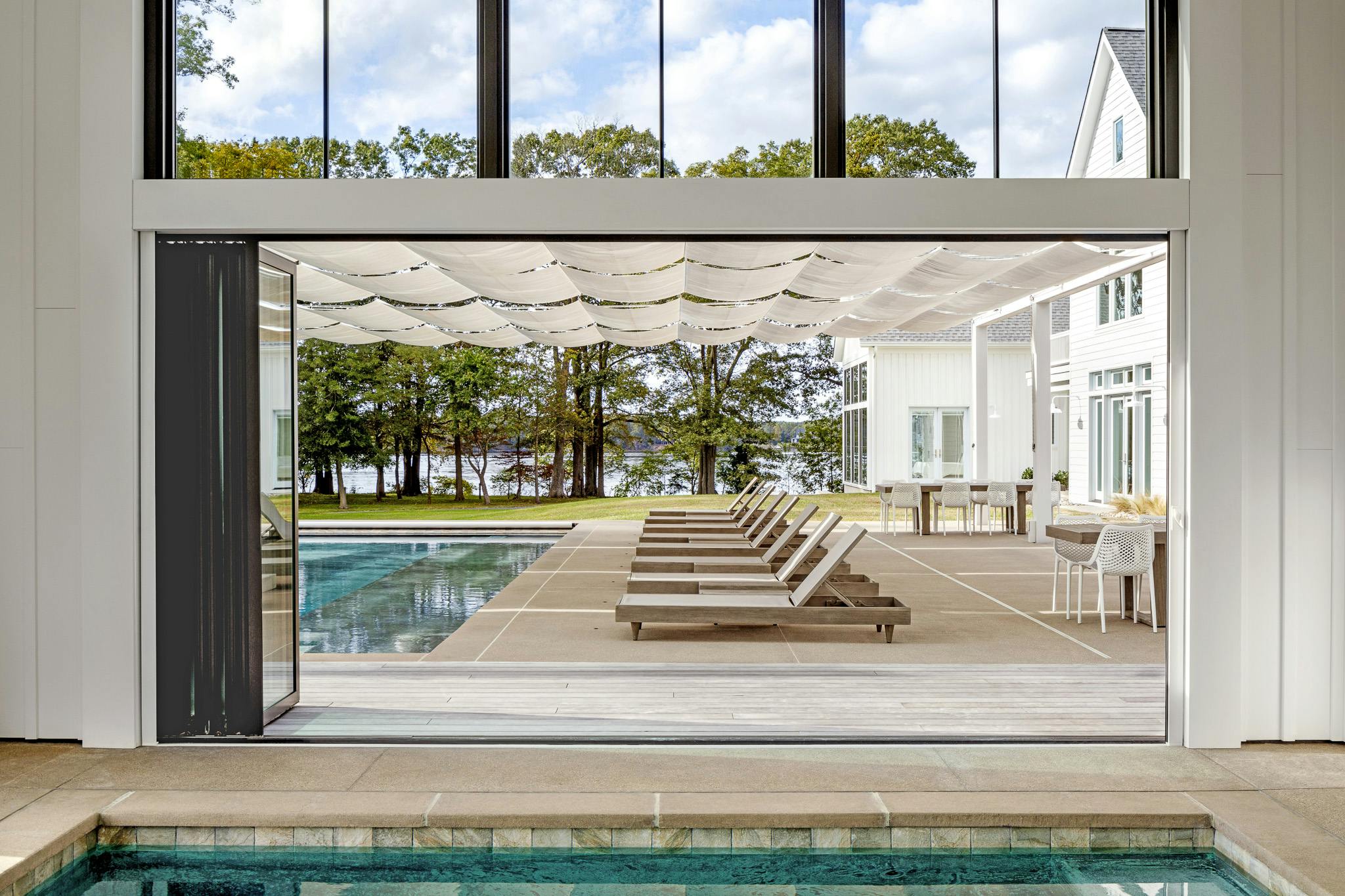NanaWall folding glass doors create indoor outdoor pools