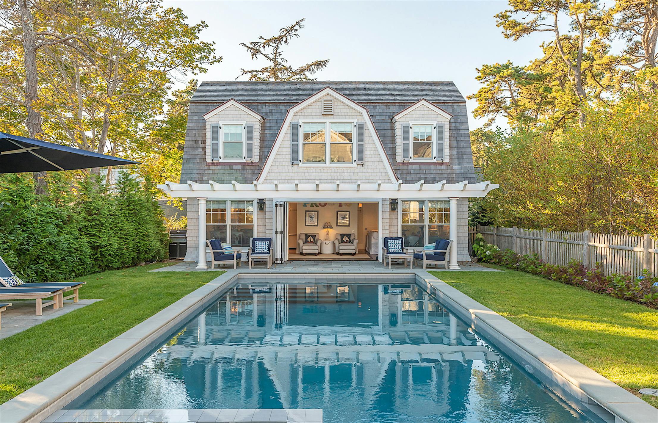 pool house design with clad folding glass walls