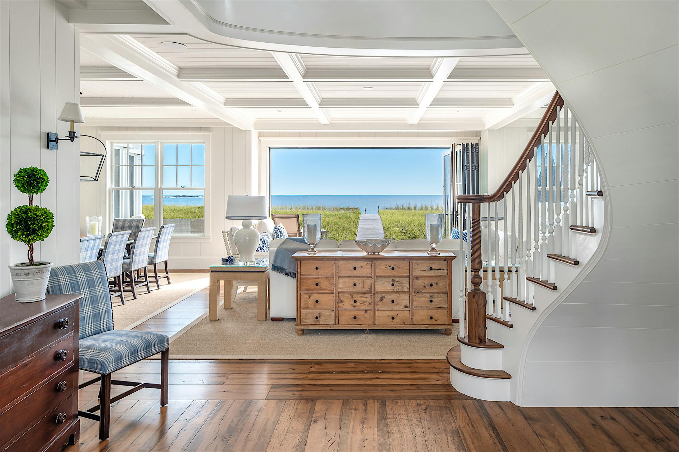 ocean view home with folding glass doors