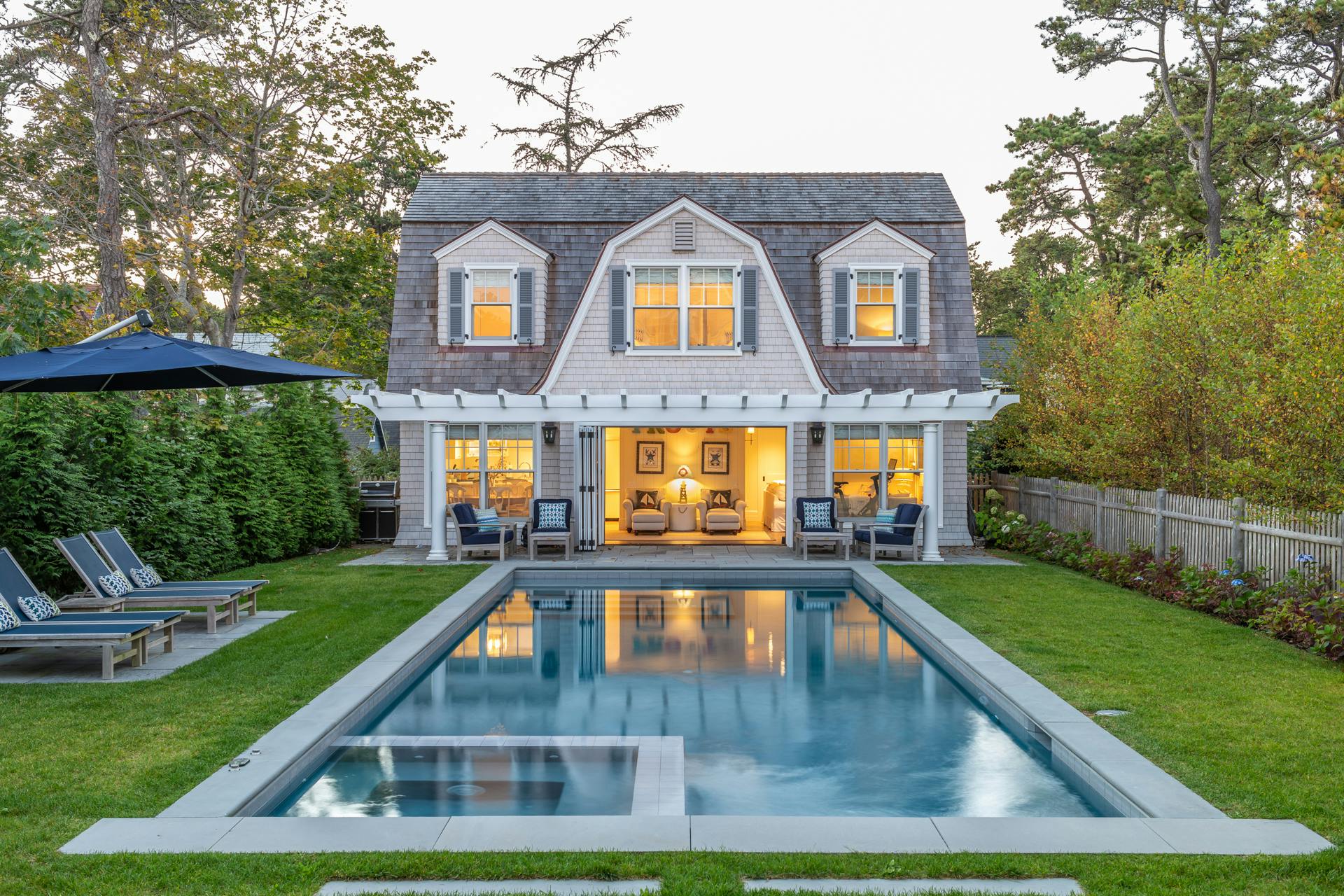 traditional pool house with operable glass walls