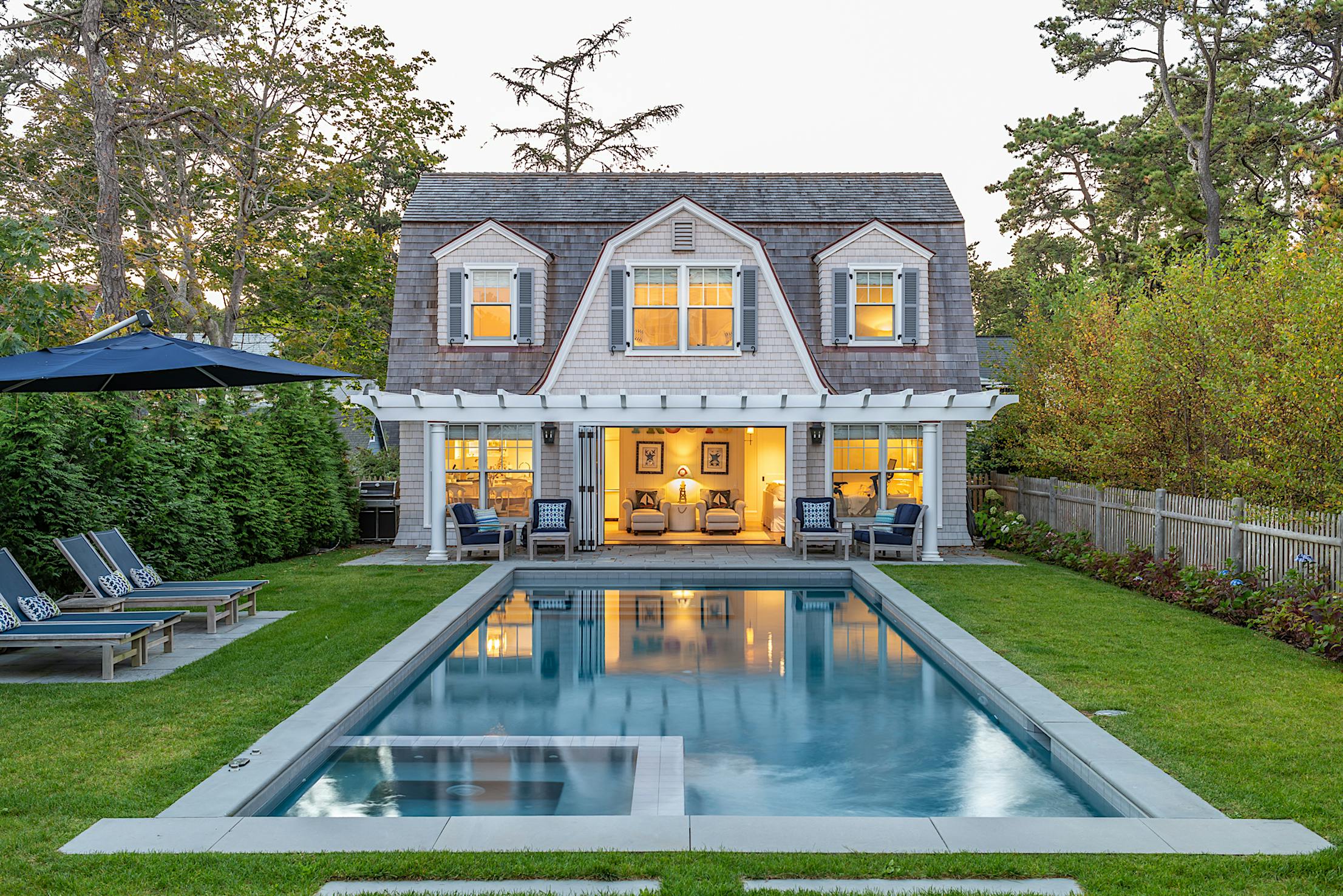 traditional pool house with operable glass walls