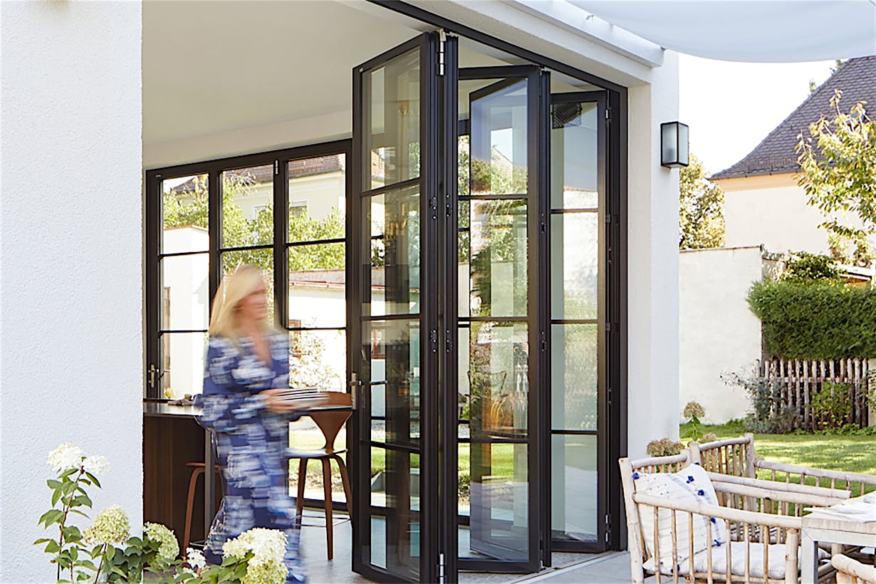 Modern Design with black framed steel look folding glass walls