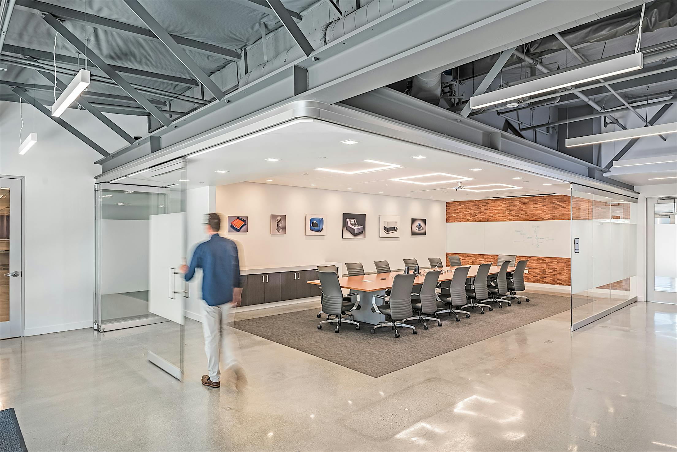 frameless opening glass wall system in workspace