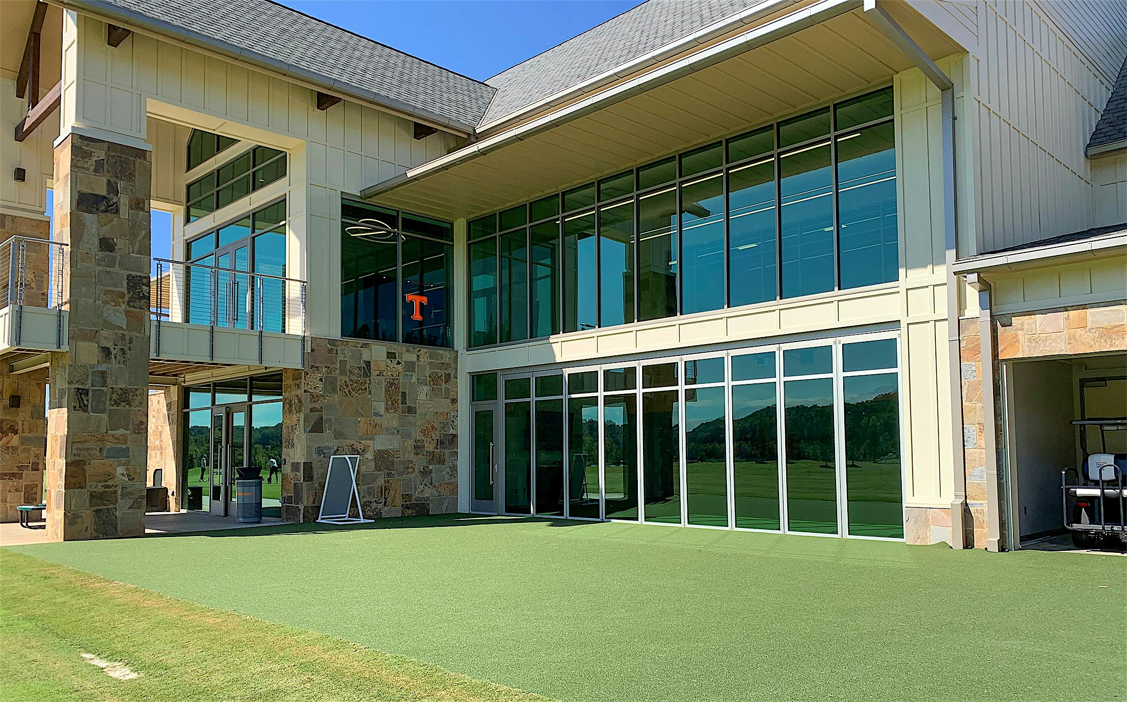 indoor outdoor putting green with NanaWall sliding glass walls