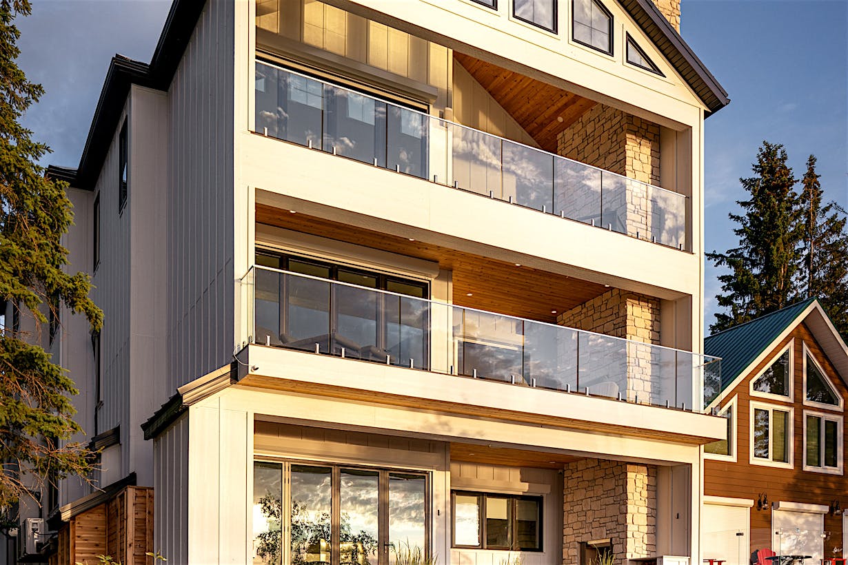 NanaWall energy-efficient folding glass doors on three levels of lakefront home