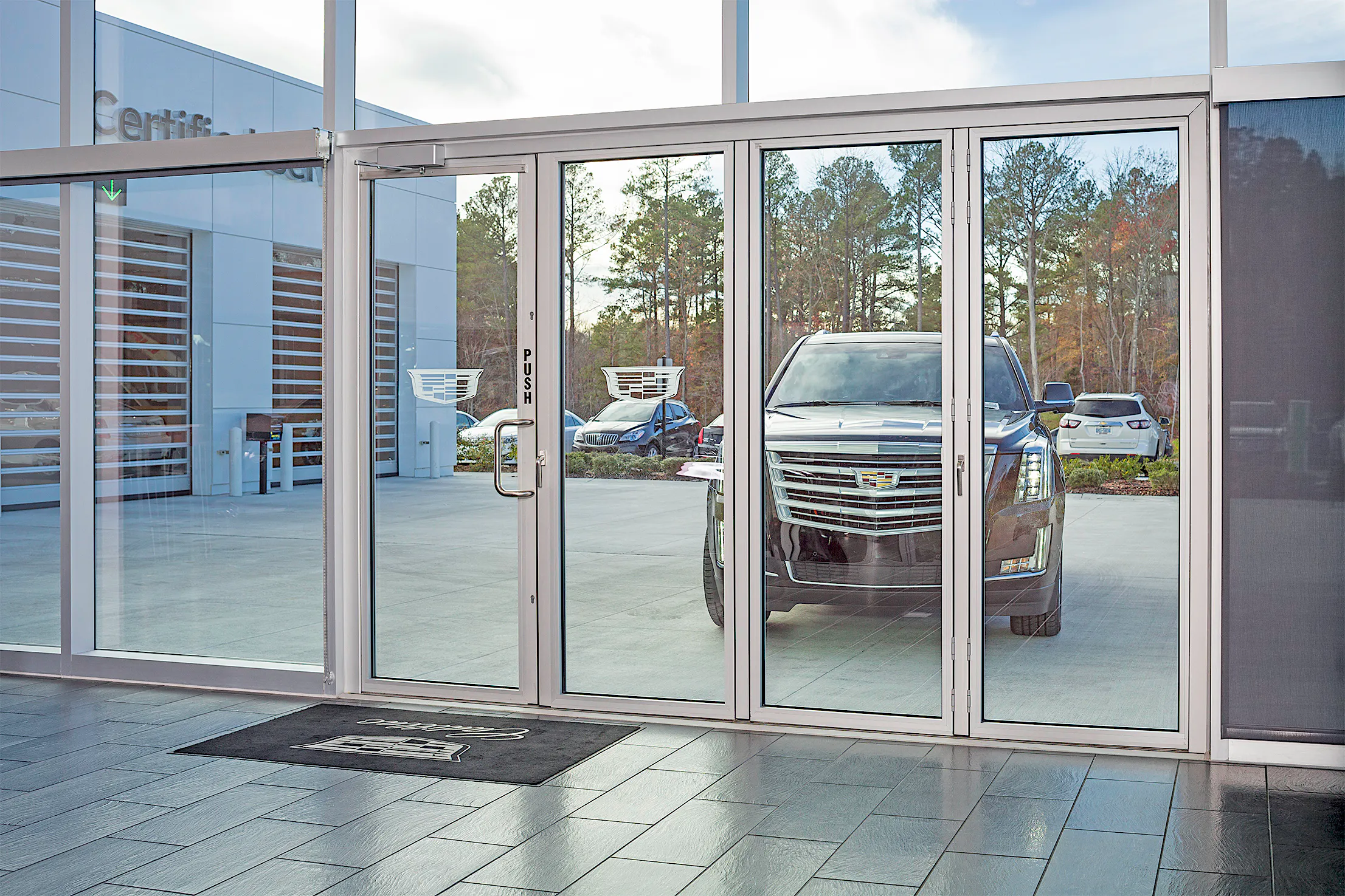 Car Storefront View Luxury Auto Dealerships with Folding Glass Doors: A New Era in Design