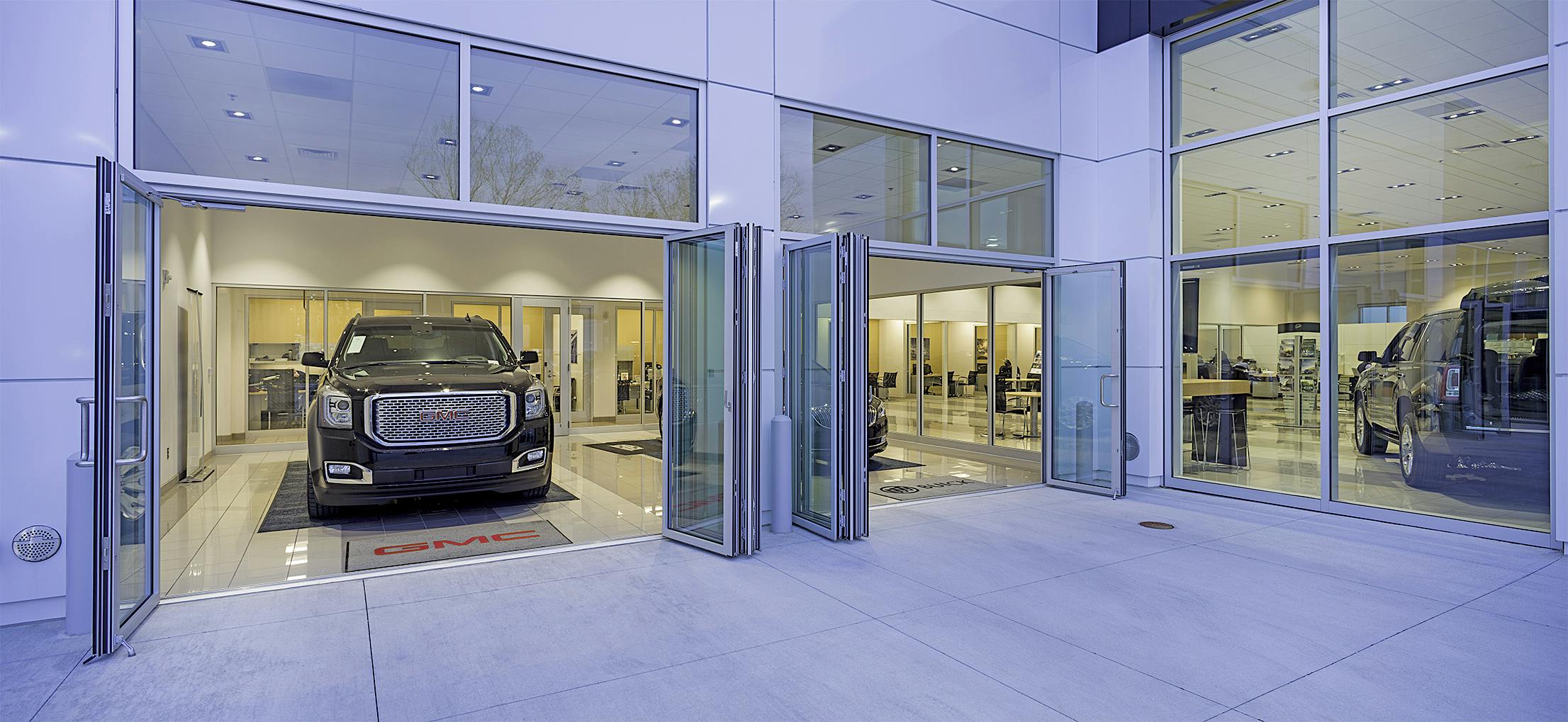 folding glass door systems in auto dealership design