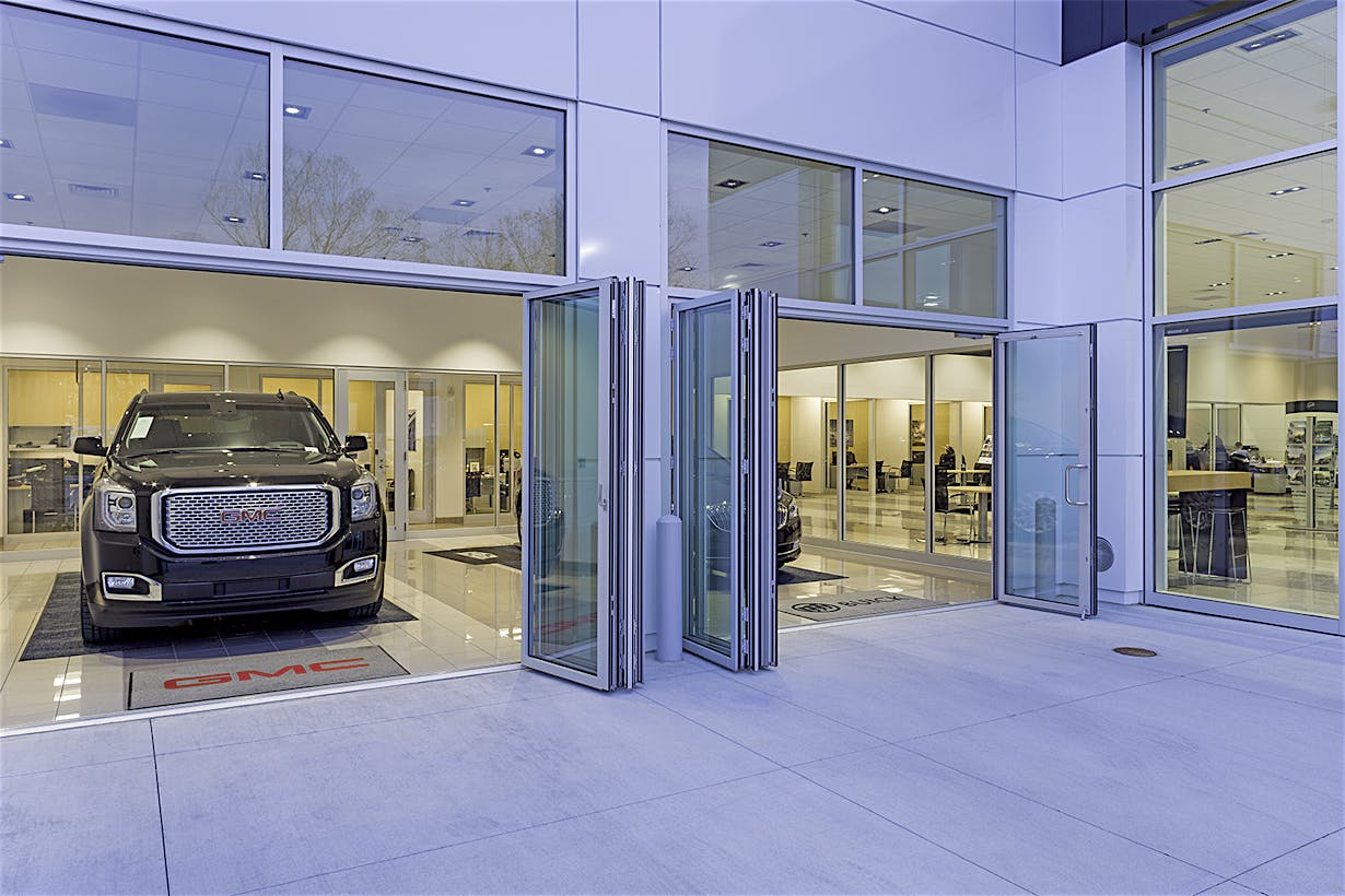 folding glass door systems in auto dealership design