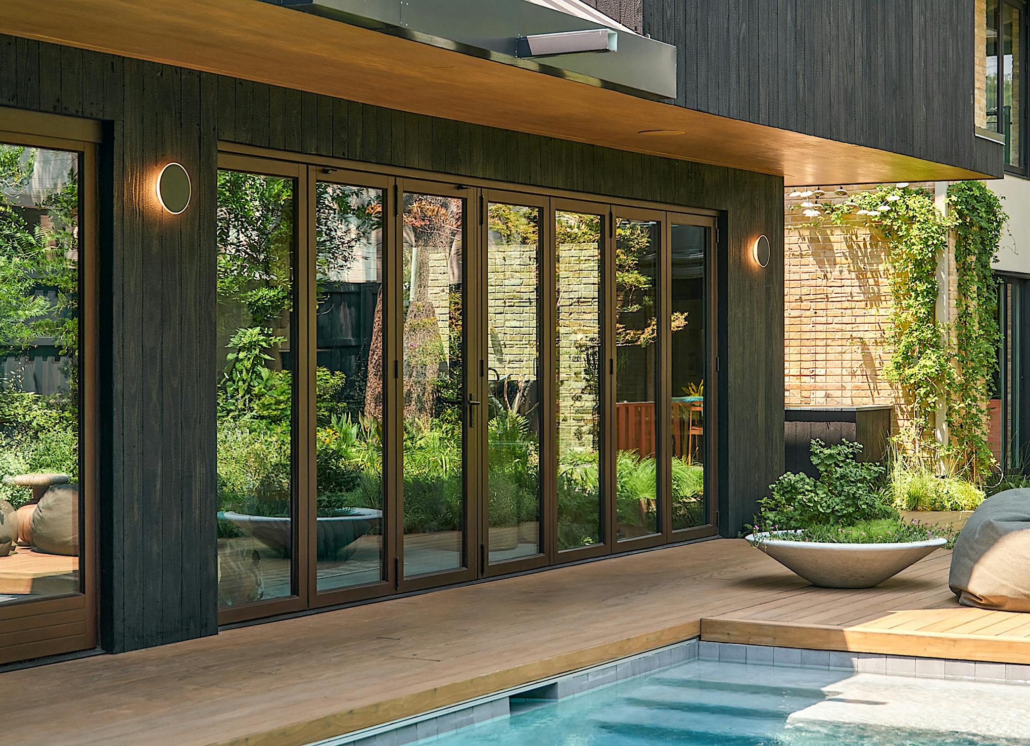 opening glass door system in pool house design