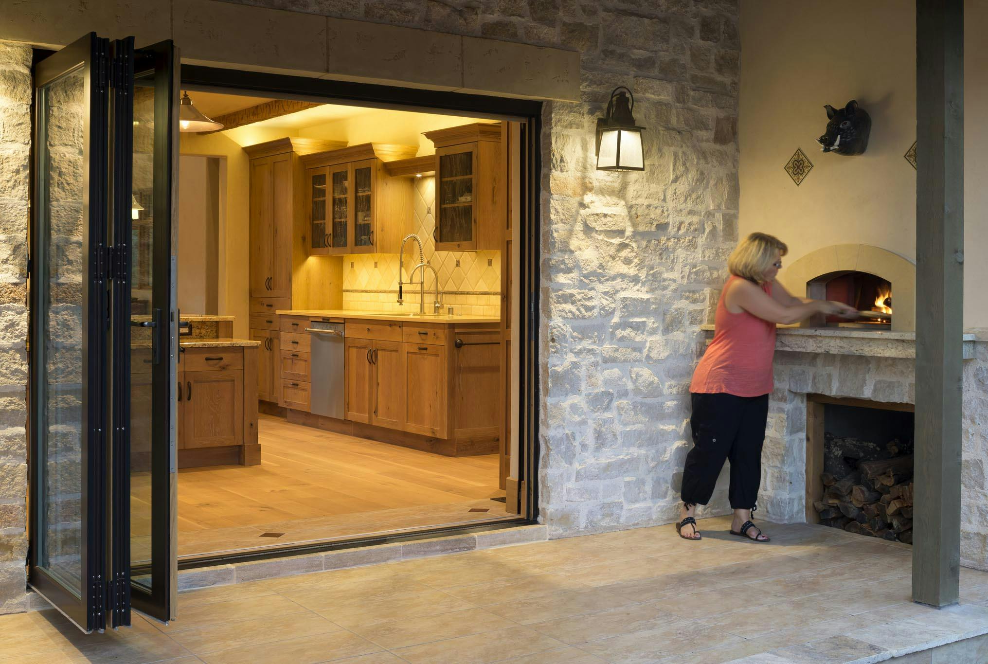 Woman enjoys the flexibility of indoor/outdoor kitchen