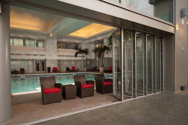 Folding-Glass-Wall-Systems-Provide-Pool-Access