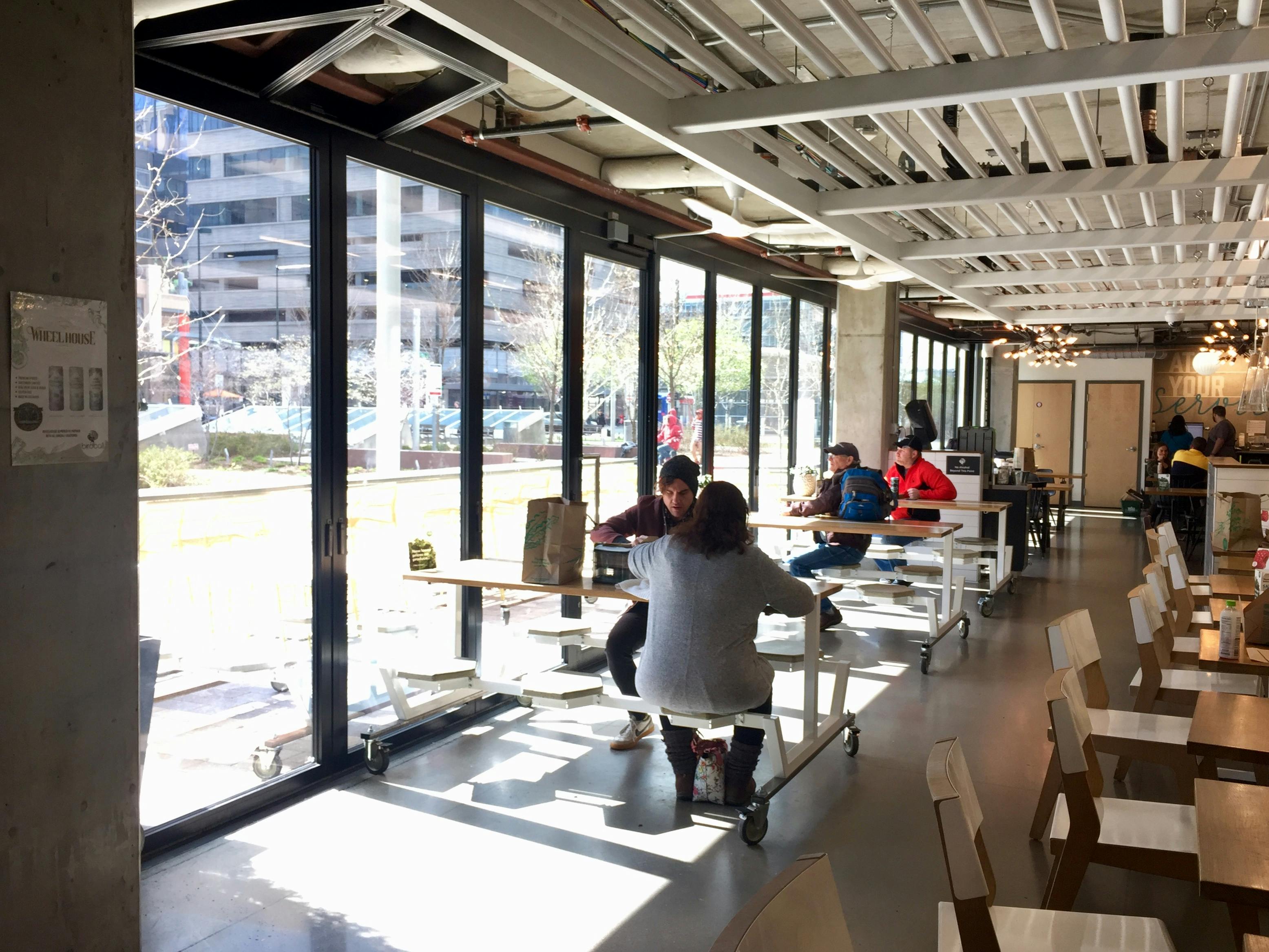 Diners eating right up next to the NanaWall HSW60 on cold winter day