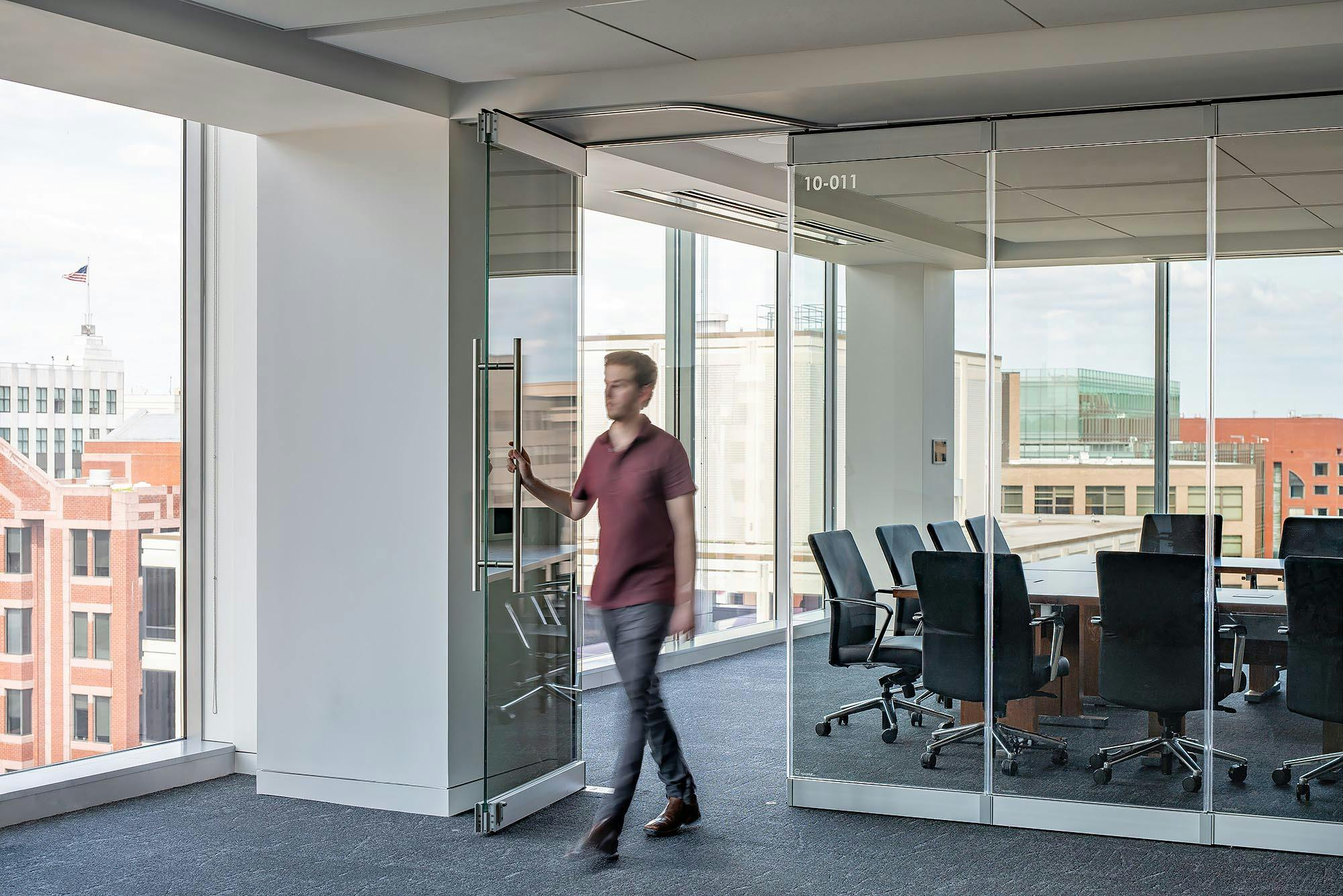 walking-through-swing-door-in-frameless-glass-wall