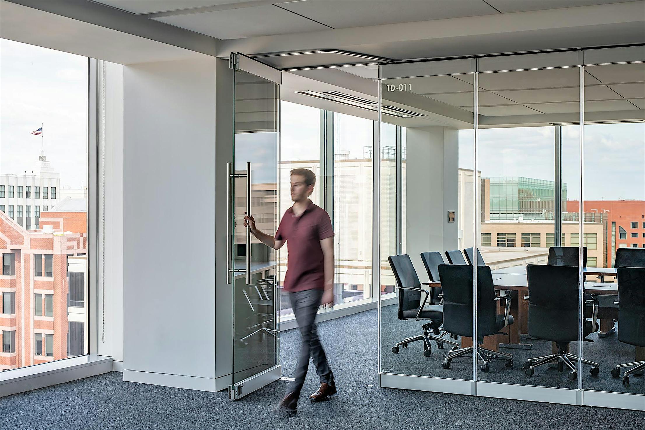 walking-through-swing-door-in-frameless-glass-wall