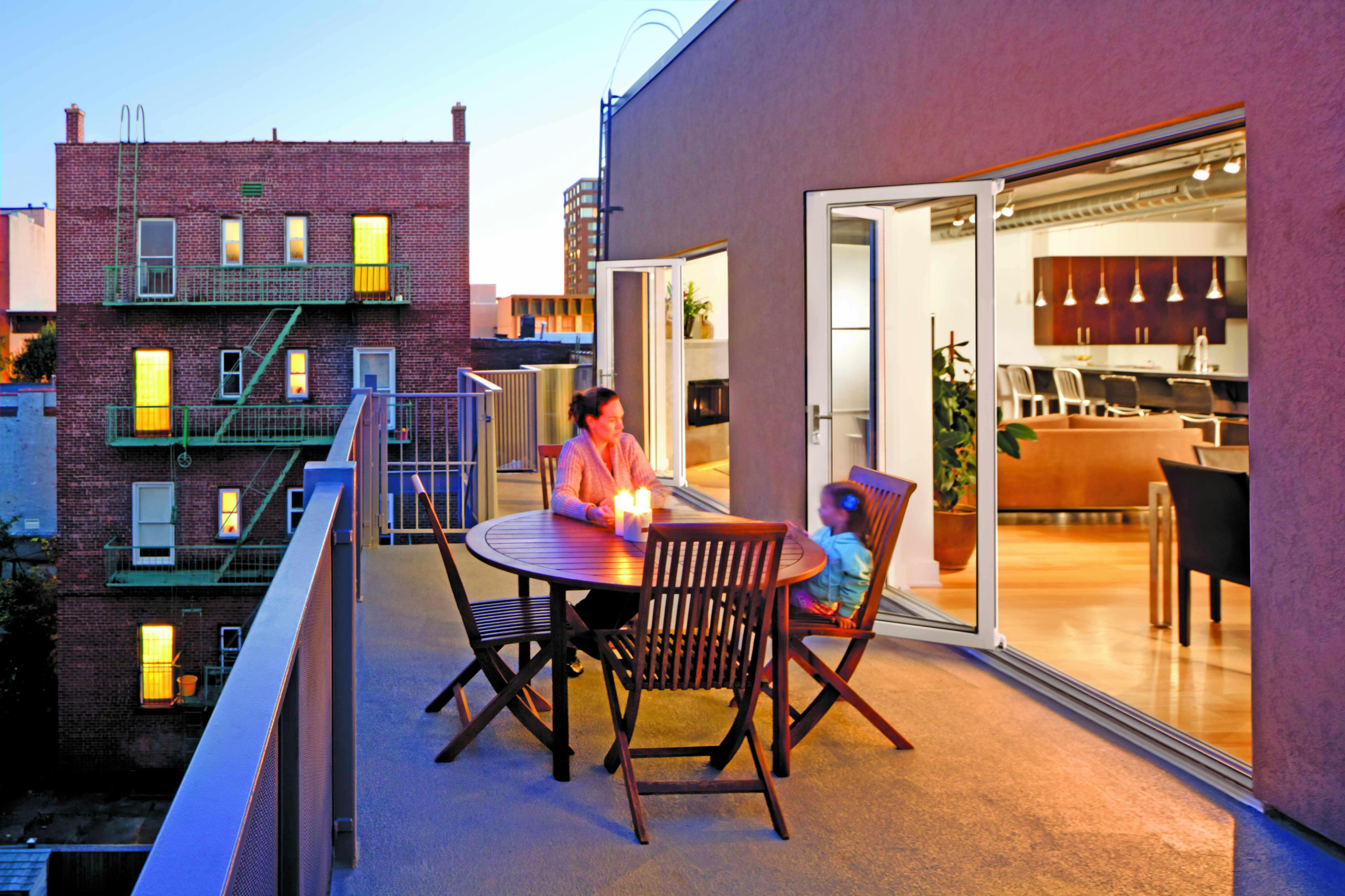 urban-multifamily-residential-deck-with-glass-walls-and-mother-and-child