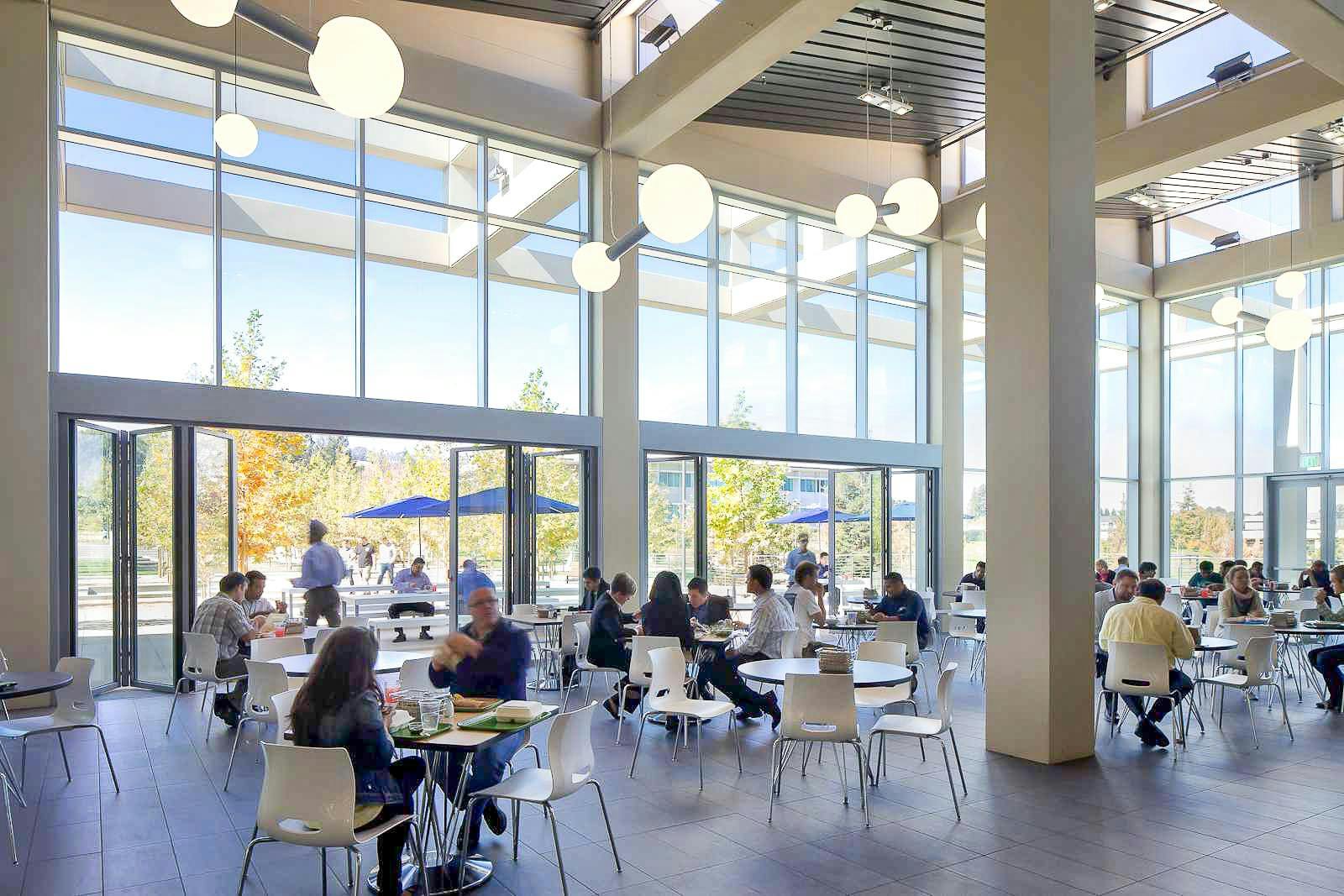 Employee-cafateria-area-with-folding-glass-walls-for-indoor-outdoor-connection