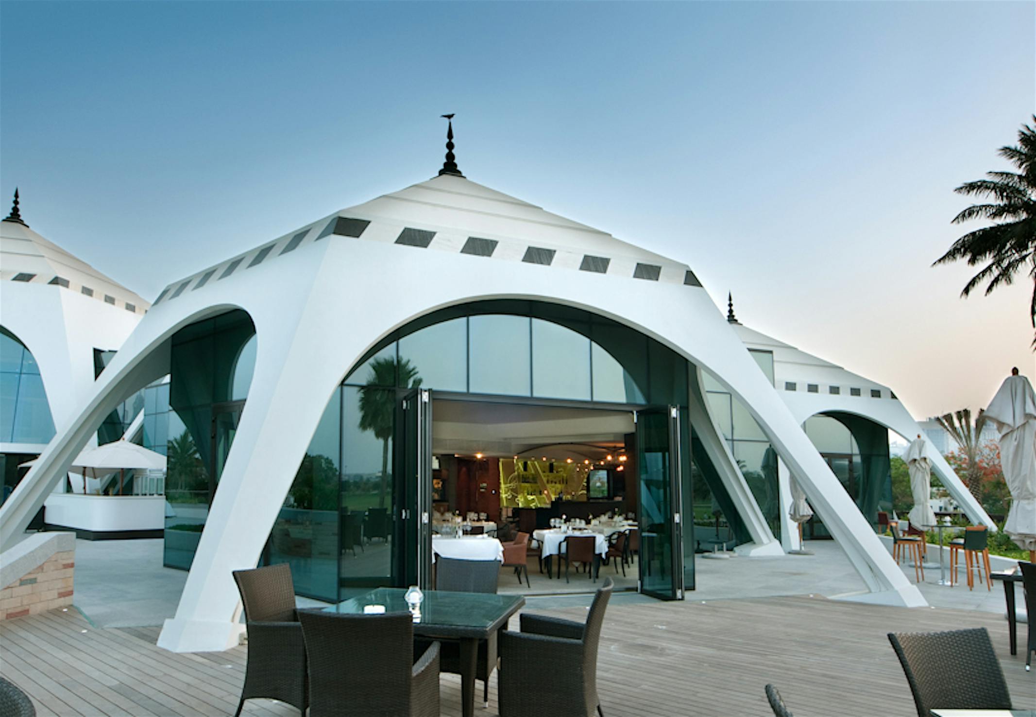 pyramid-shaped-golf-club-venue-with-opening-glass-wall