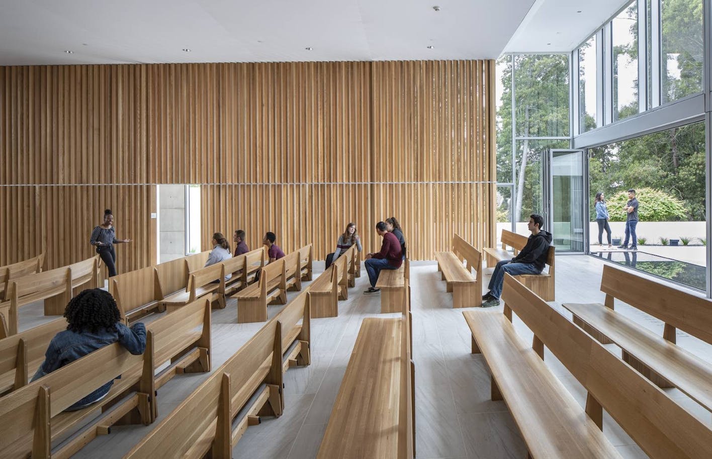 people-sitting-in-church-with-folding-glass-wall