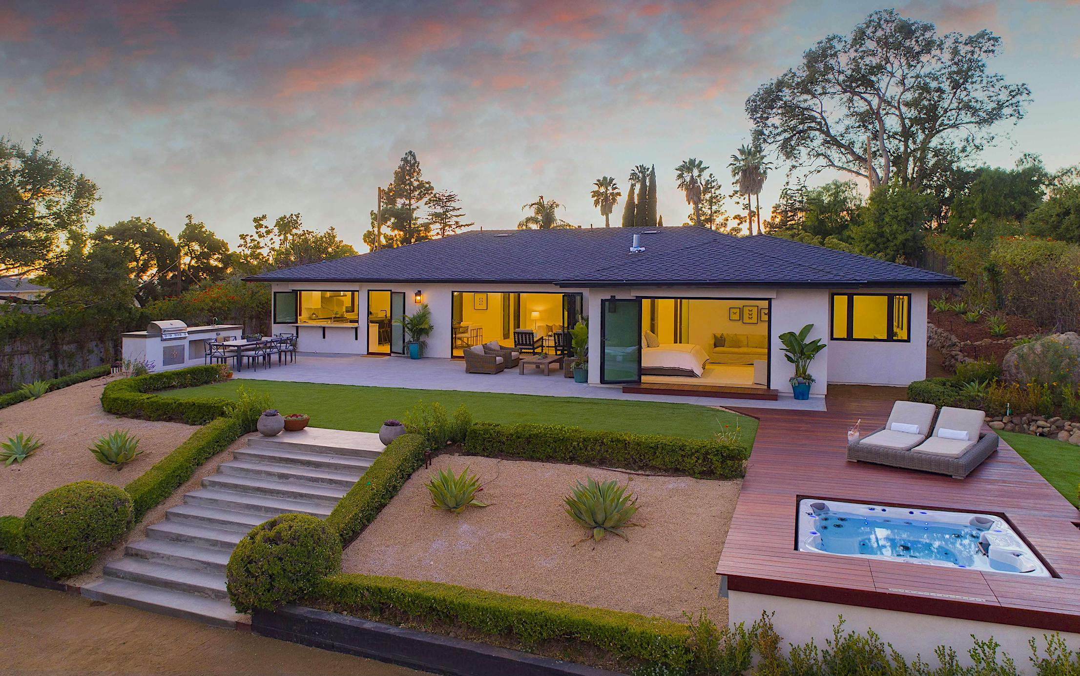 rear-exterior-of-mid-century-modern-home-with-large-opening-glass-walls