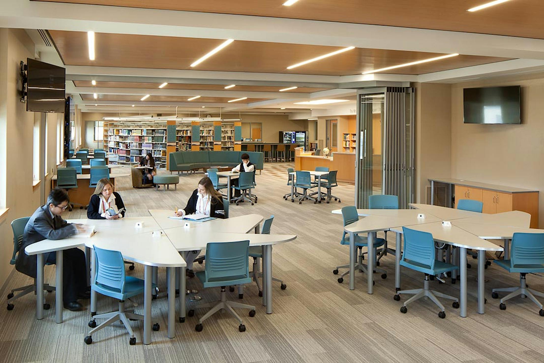 scholastic renovation in libraty with stacking glass doors