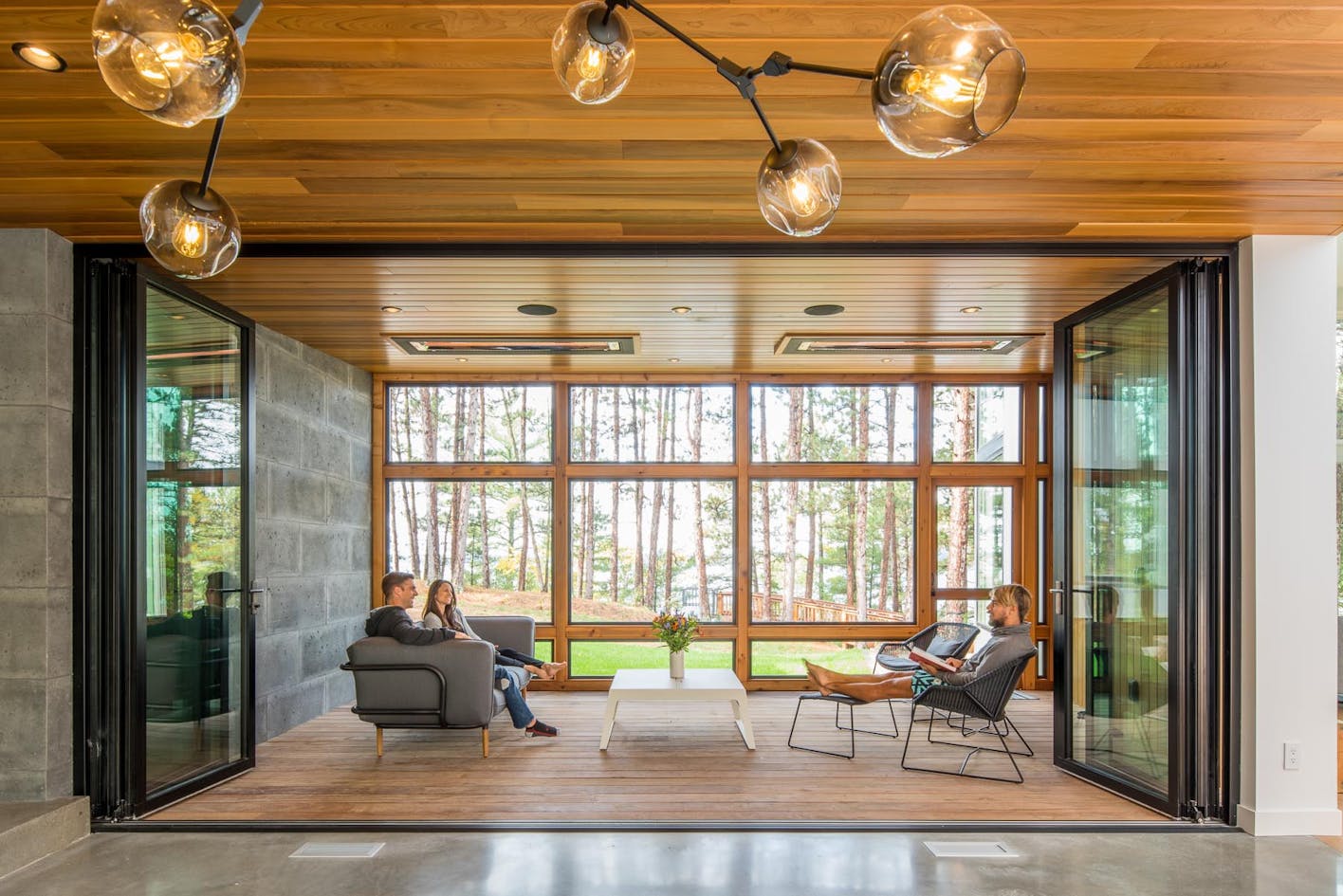 An expansive 3-season porch highlights this modern cabin in Minnesota. 