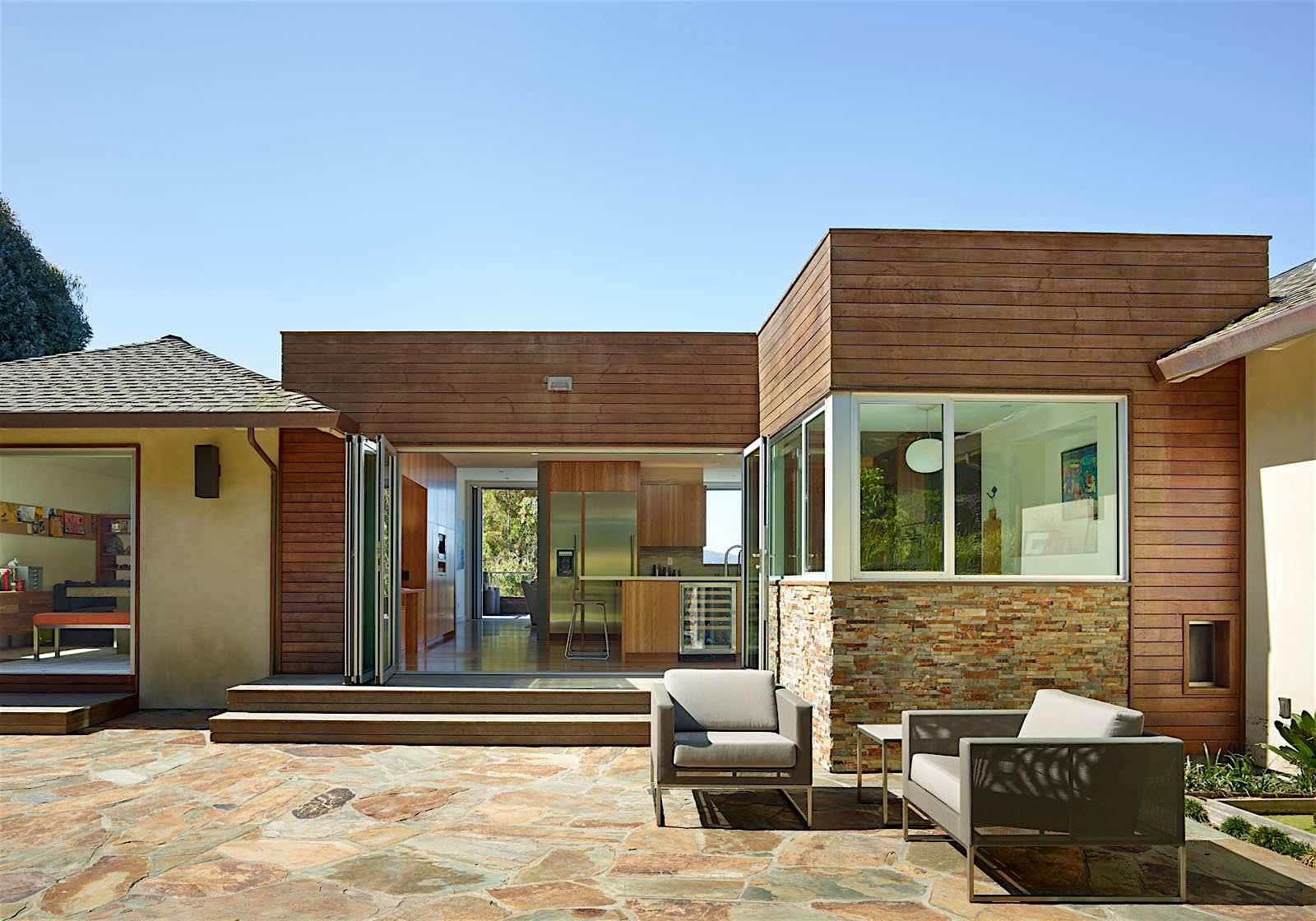 Mid-Century-Modern-exterior-with-NanaWall-glass-wall-system-connecting-kitchen-to-outdoor-patio