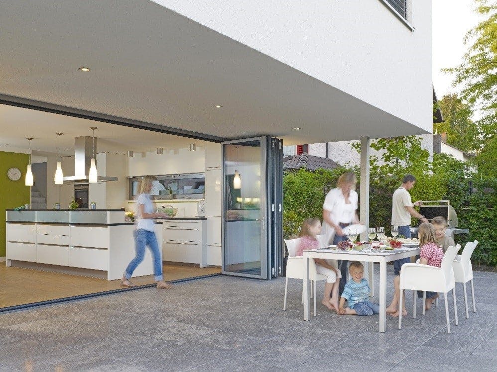 Family enjoying indoor/outdoor kitchen.