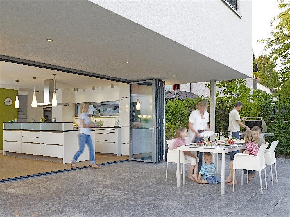 Family enjoying indoor/outdoor kitchen.