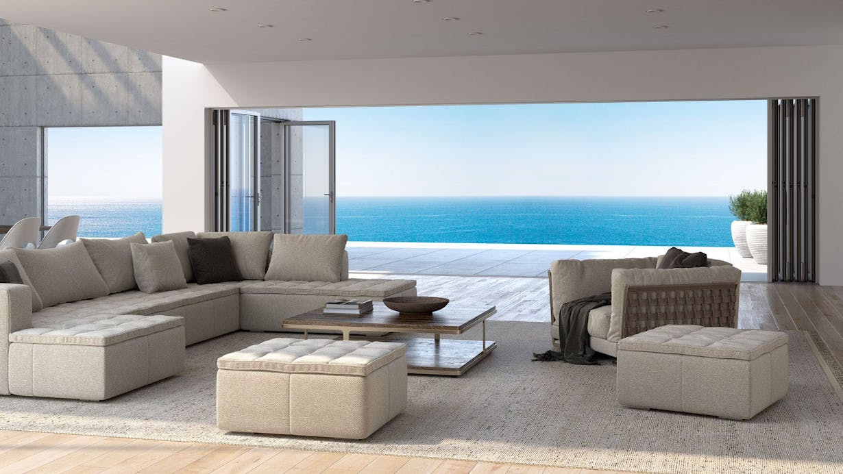A living room with folding glass walls for a stunning view of the ocean