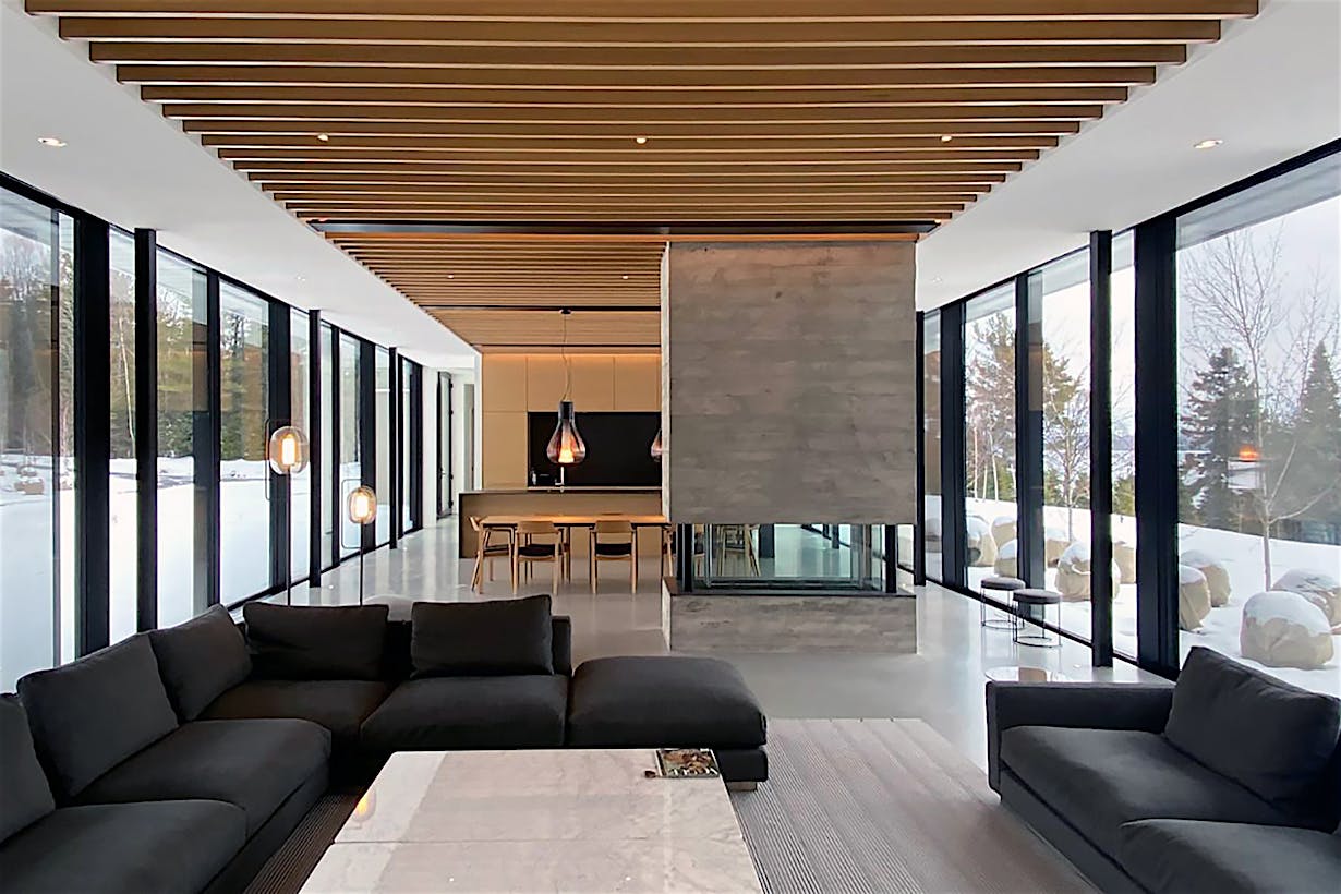 A living room with full floor to ceiling sliding glass panels