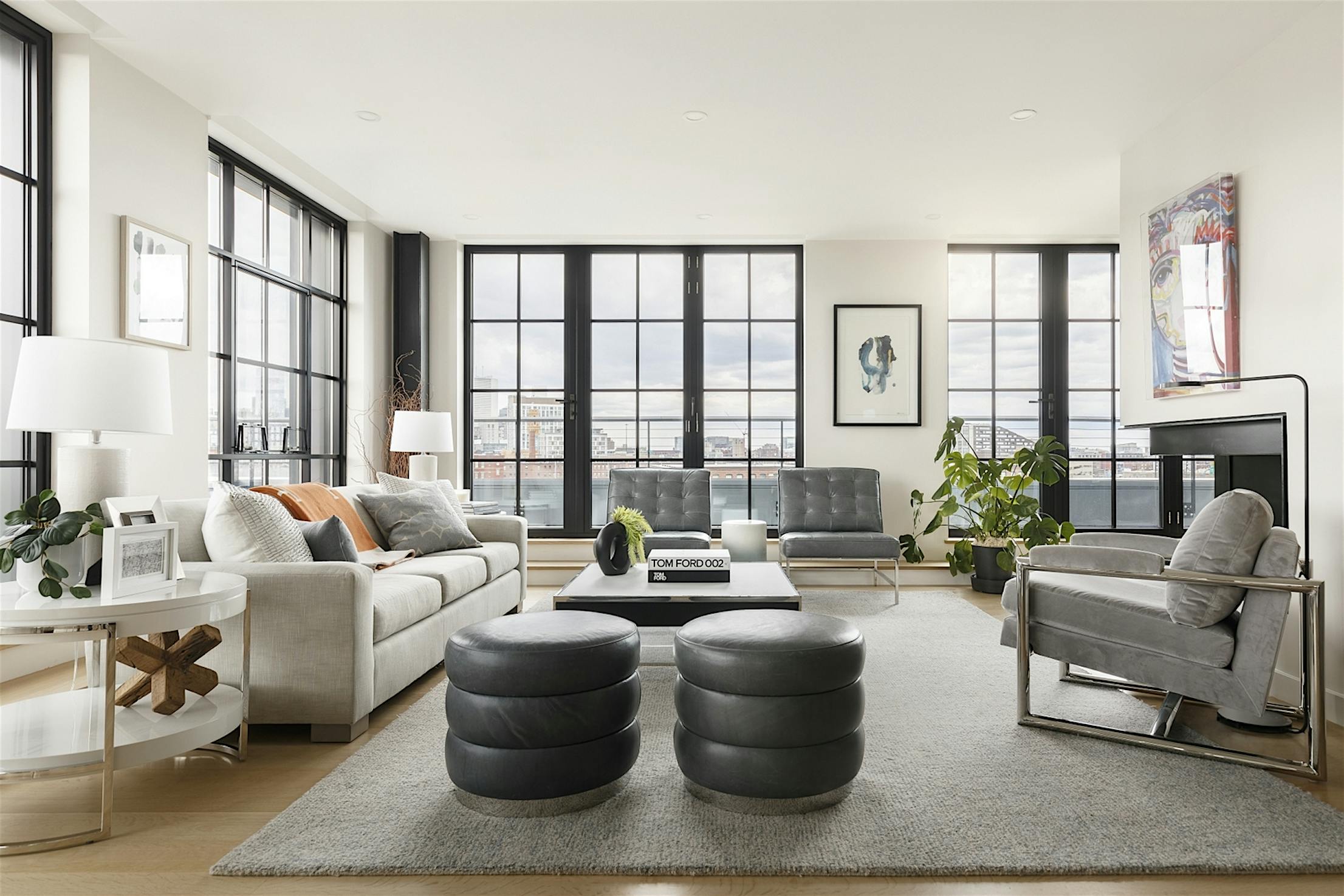 A living room with large windows and a coffee table