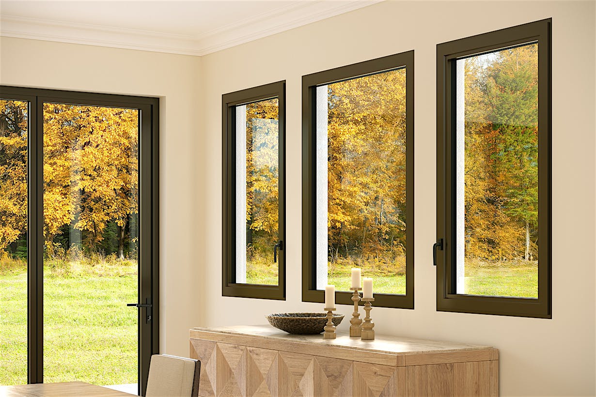 Three fixed windows in a beige dining room reveal an autumn landscape with trees and grass.