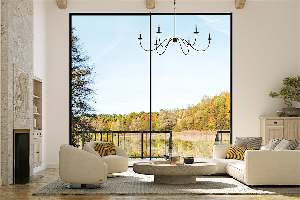 Large panel sliding glass walls offer an uninterrupted view of coastal mountains, lush greenery, and the ocean.