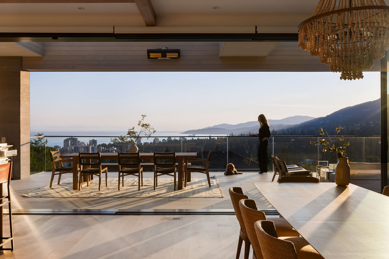 A dining room with flexible space glass walls offering breathtaking views of the mountains