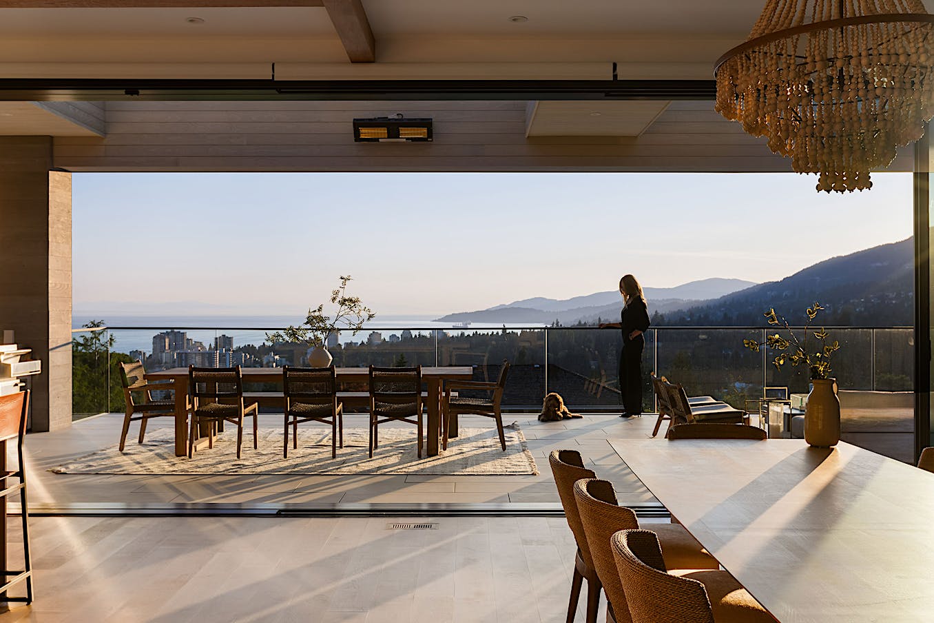 A dining room with flexible space glass walls offering breathtaking views of the mountains