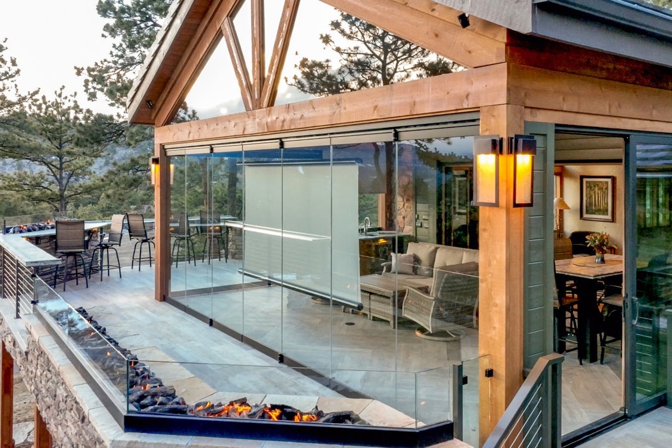 Frameless patio doors with a fireplace and a view of the mountains