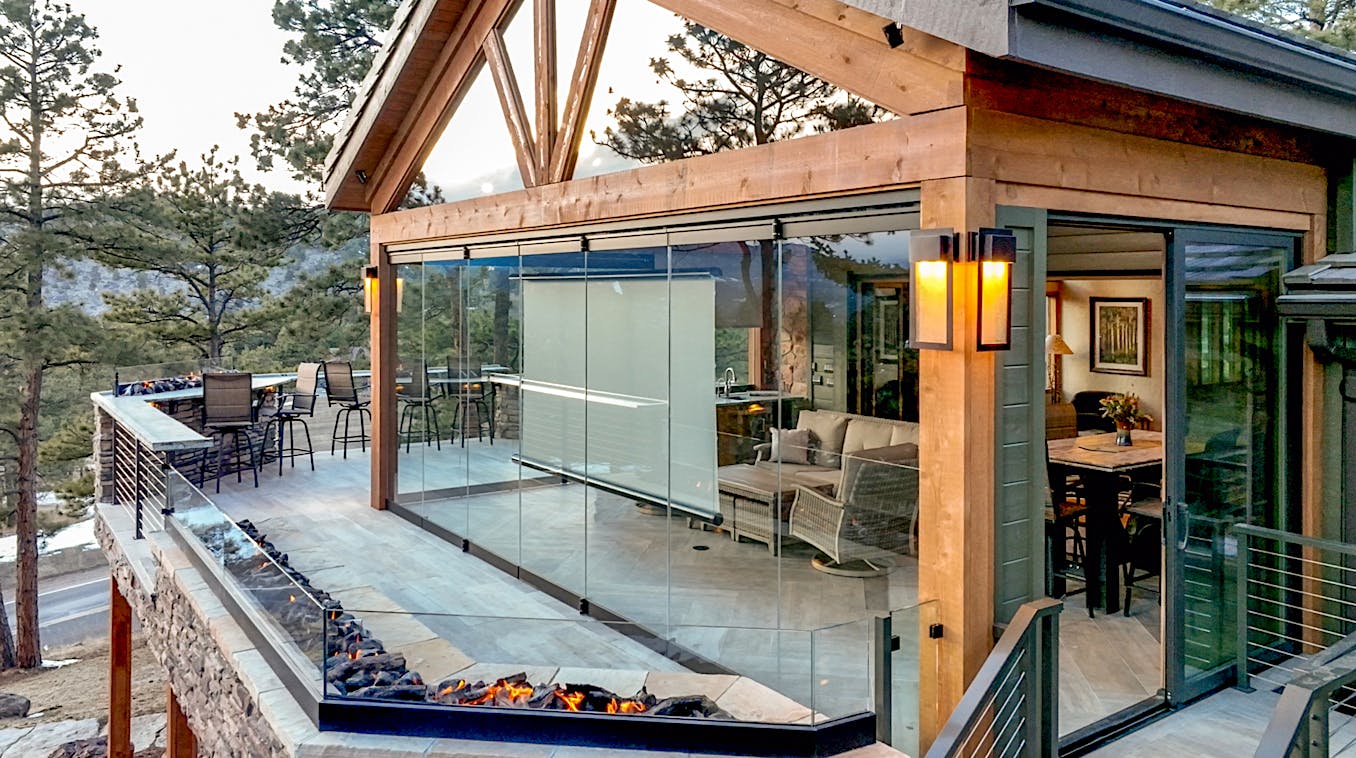 Frameless patio doors with a fireplace and a view of the mountains