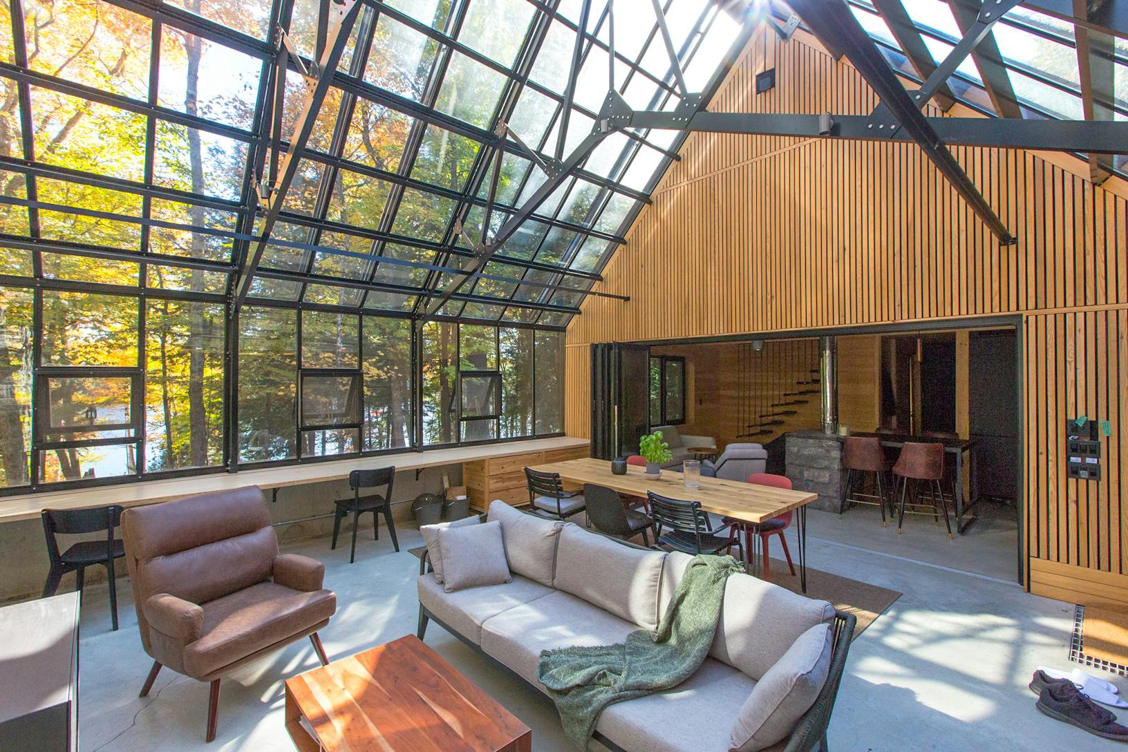 A stunning wintergarden featuring glass walls and a glass roof