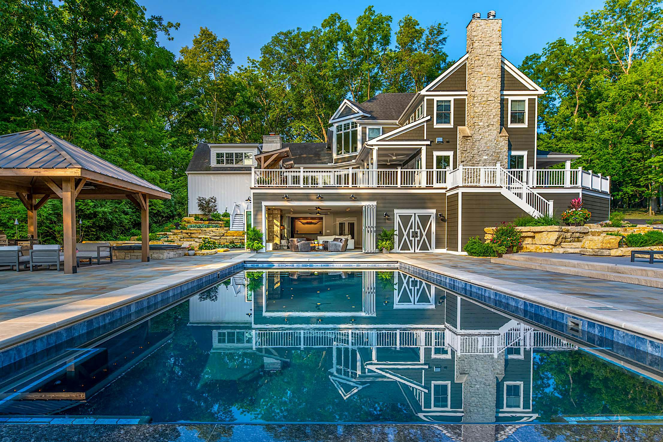 Accordion glass doors at Columbus, OH River House, seamlessly blending indoor and outdoor spaces with modern design